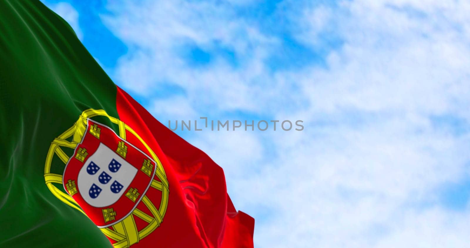 Close-up of Portugal national flag waving in the wind on a clear day. Portuguese Republic is a Member State of the European Union. 3d illustration render. Rippled textile