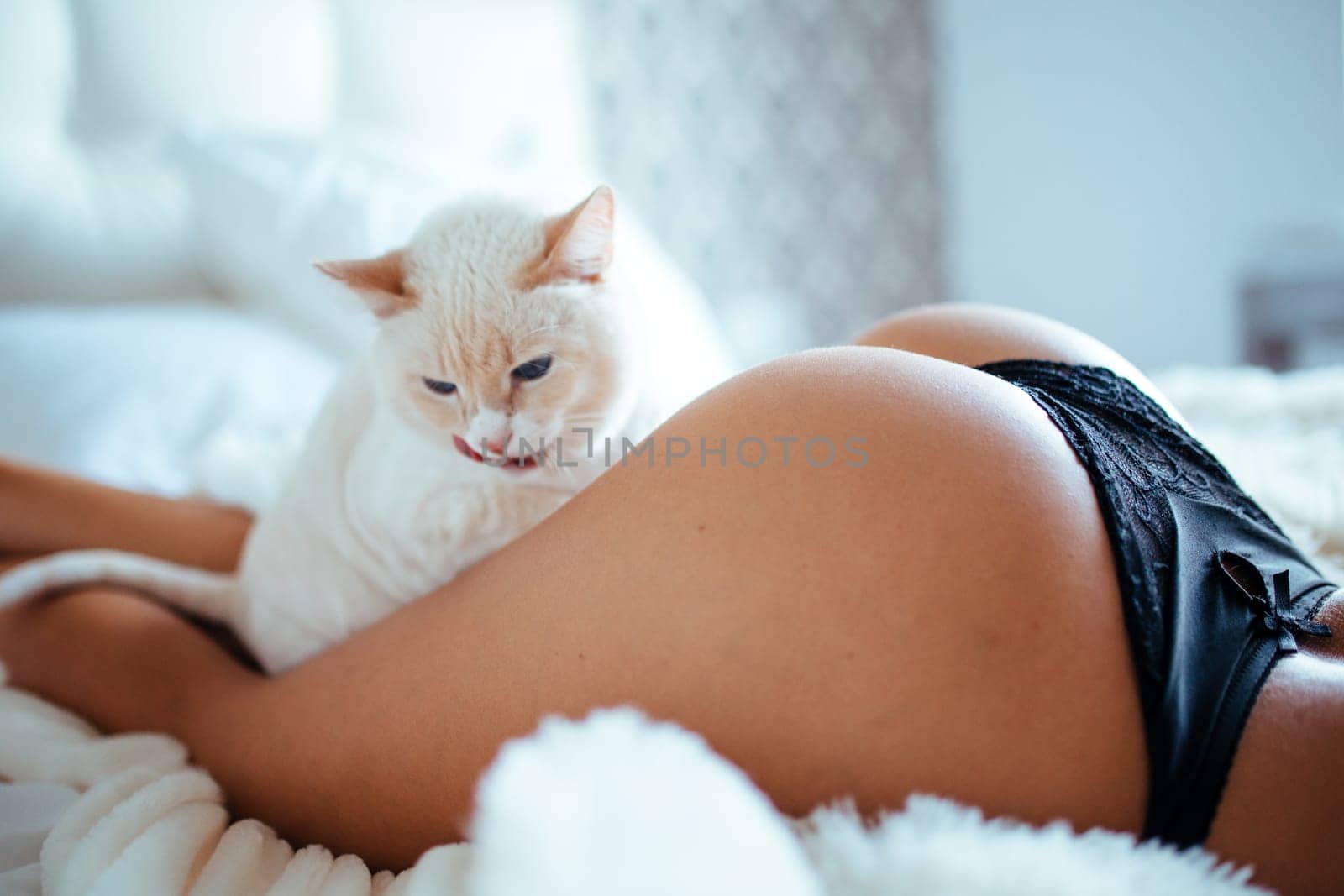 Sexy woman in bed. Attractive girl in black lingerie. High quality photo