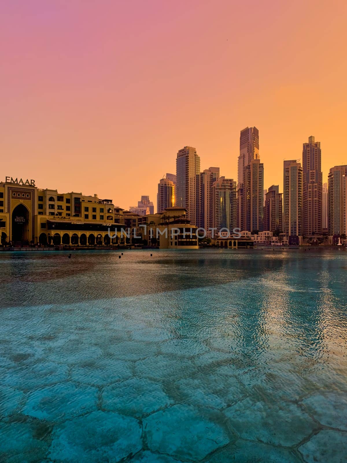UAE, Dubai, 26 December 2024: The famous shopping center Dubai Mall and Burj Khalifa skyscraper at dusk, Dubai's sights and skyscrapers illuminated at night, palm trees. High quality photo