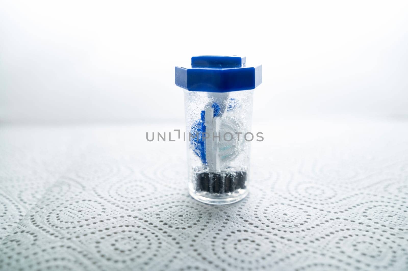 close-up of a container for cleaning and storing contact lenses for the eyes, used at home. For soft and hard lenses. in the container there is an active cleaning process, bubbles are released