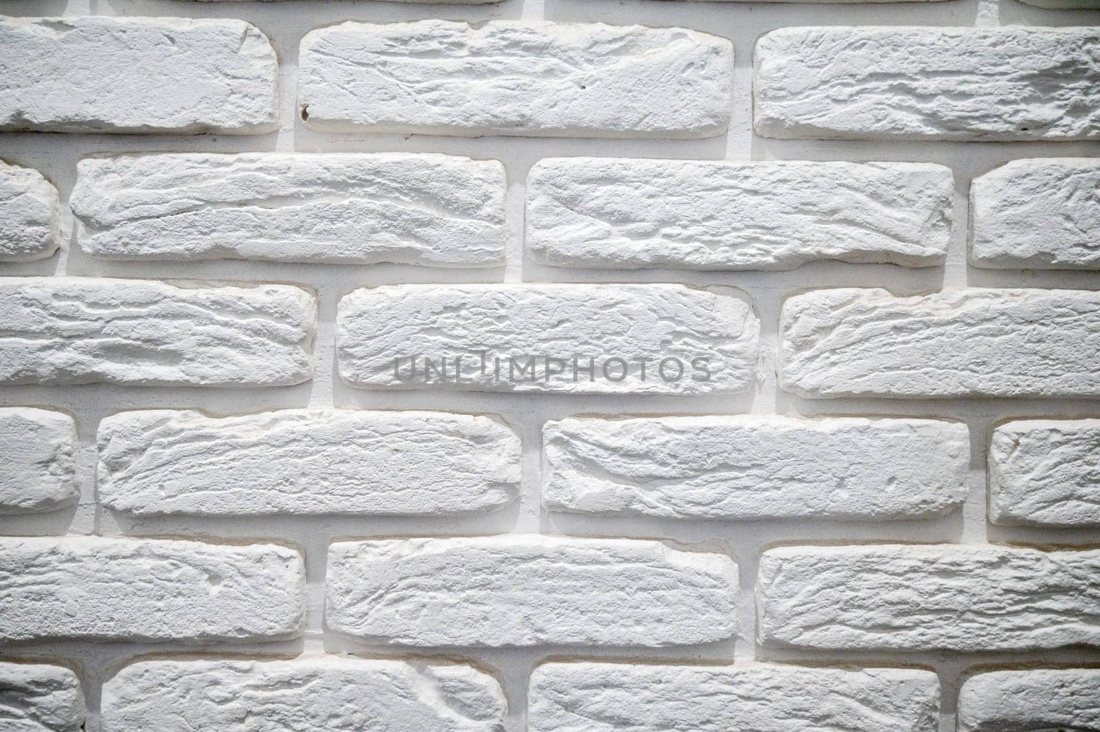 close-up of a white brick wall. large white brick, with an uneven surface.