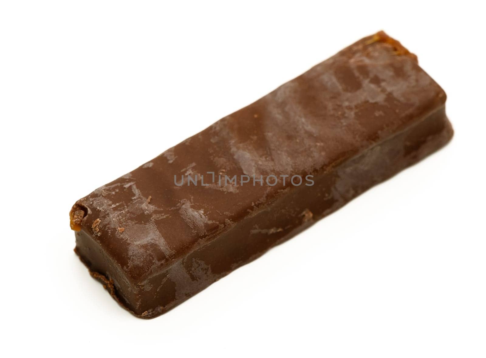 A tempting chocolate bar lies on a pristine surface, inviting taste with its glossy exterior and satisfying shape.