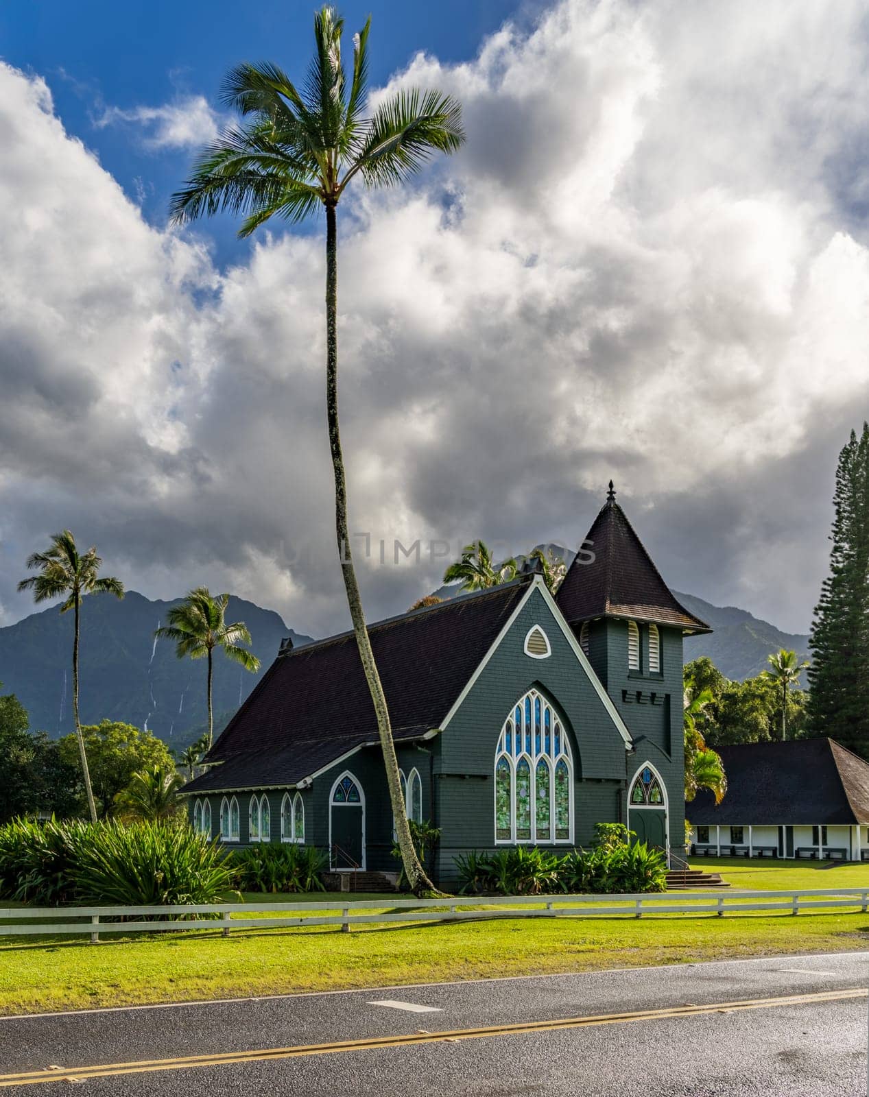 The Waioli Huiia Church stands in Hanalei, Kauai, with the majestic mountains in the background, after a heavy storm over the hills