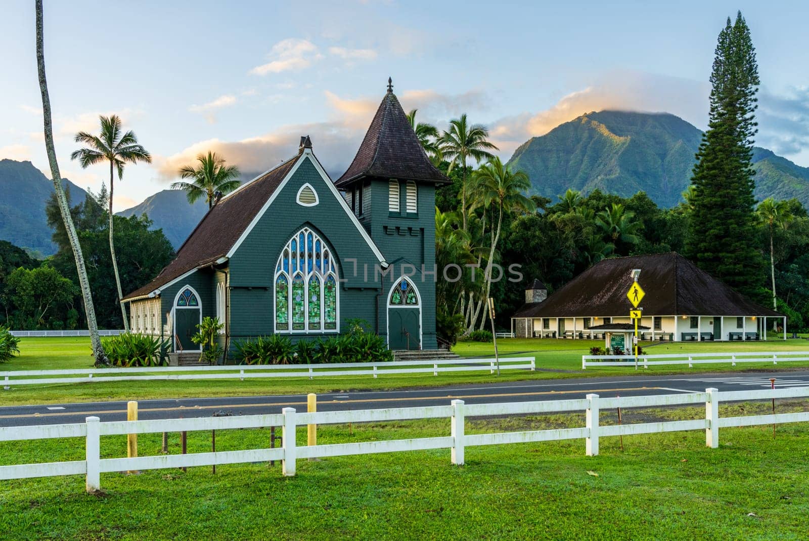 The Waioli Huiia Church stands in Hanalei, Kauai, with the majestic mountains in the background at sunrise