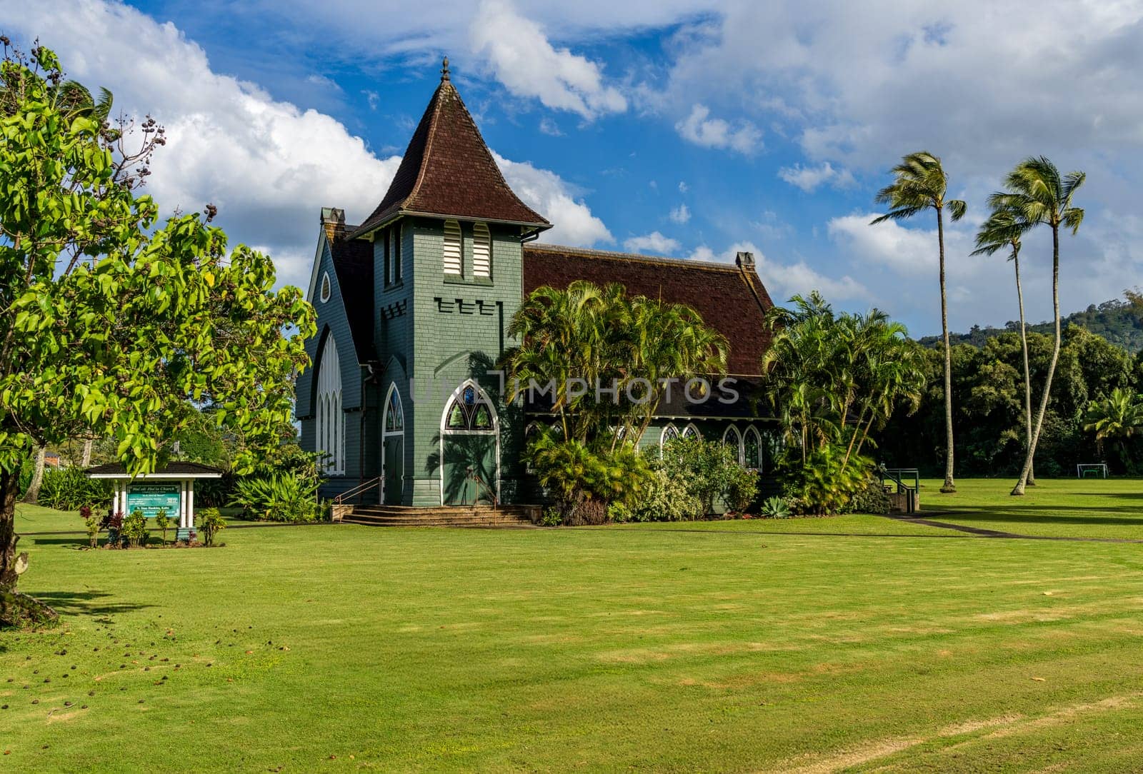 Hanalei, Kauai - 30 January 2025: Waioli Huiia Church stands in Hanalei, Kauai, with the majestic mountains in the background