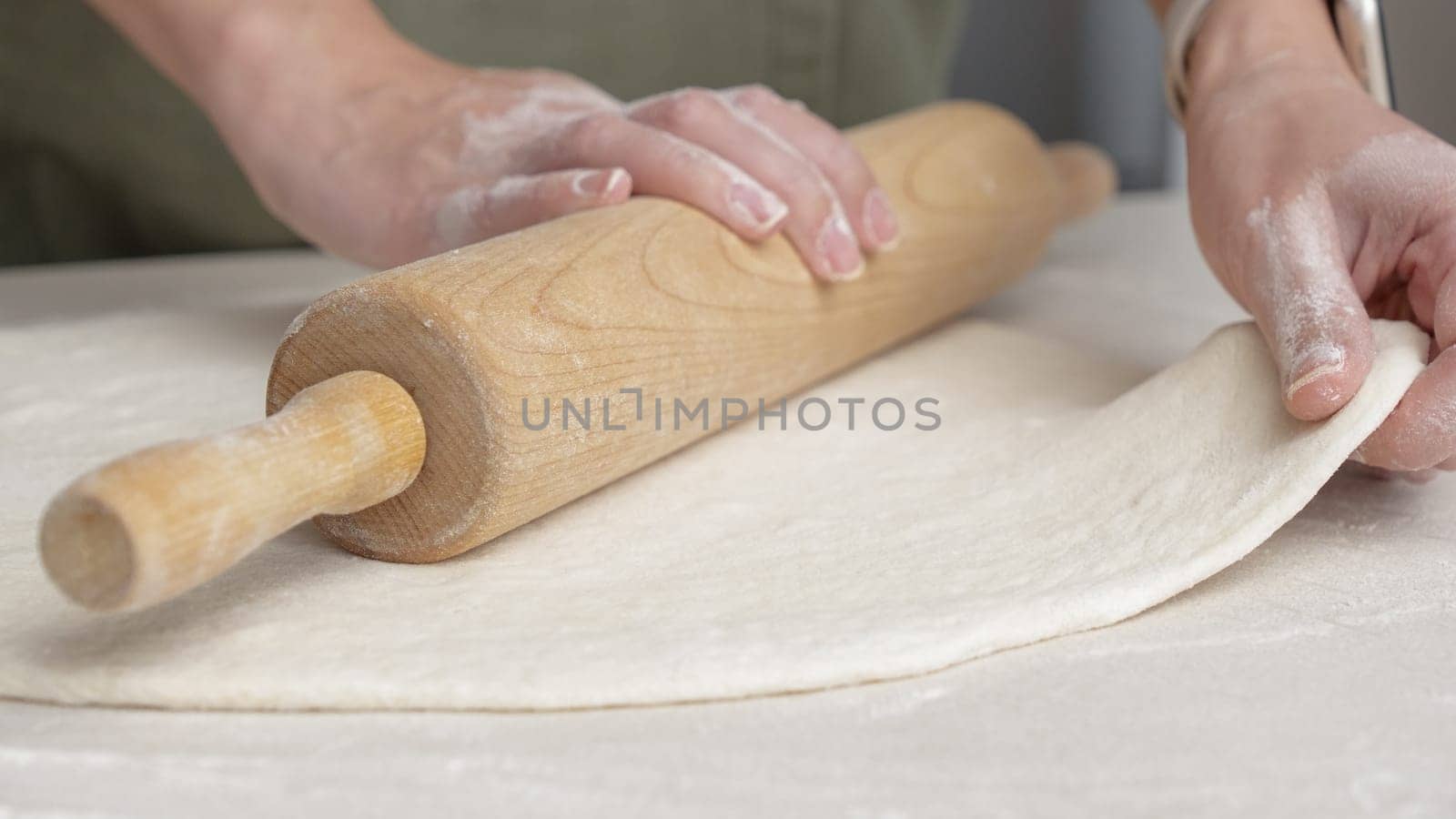 Hands Shaping the dough into ball by hand. chef Preparing the dough for baking pizza bread in the restaurant, baking.
