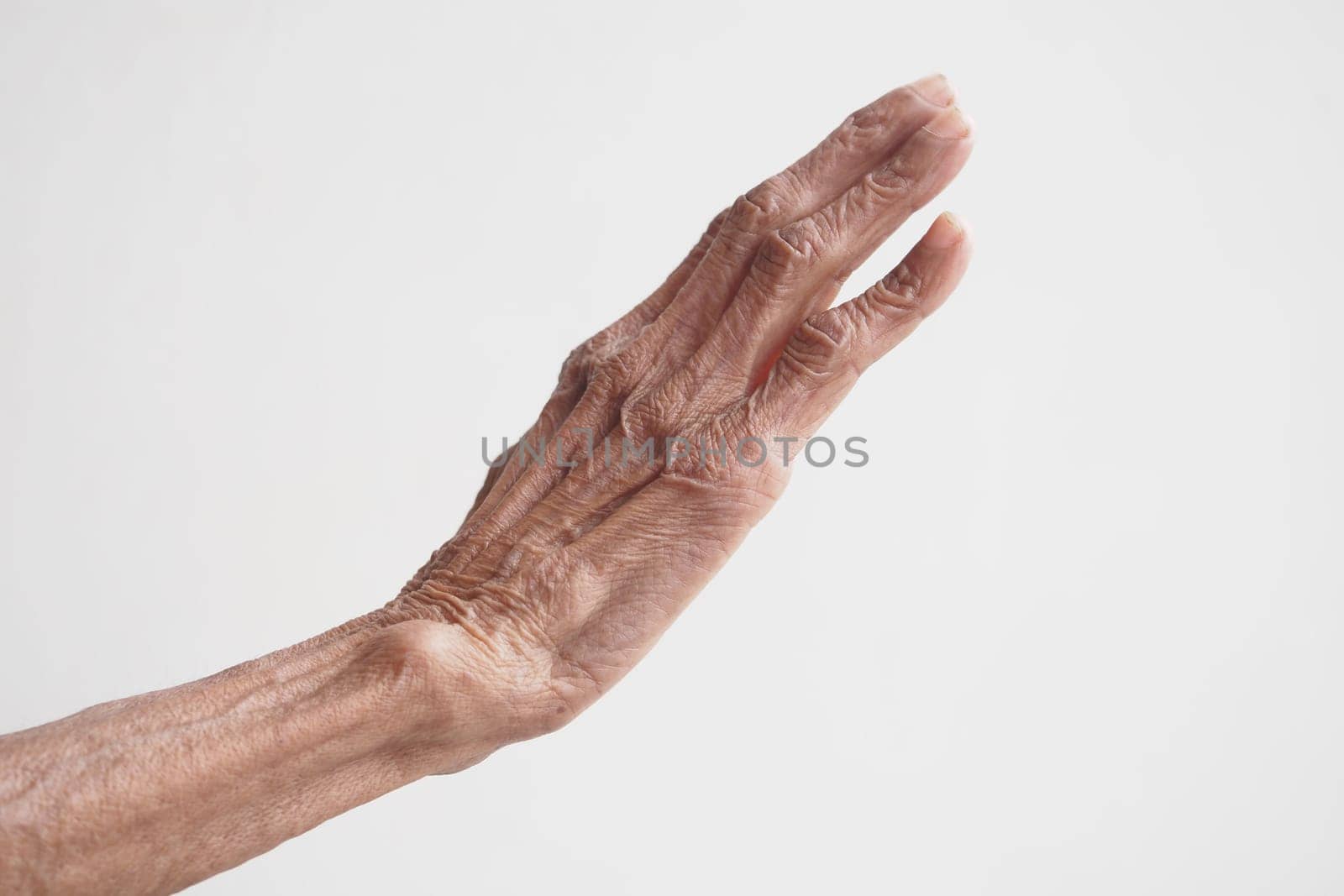 An elderly hand extends outward in a warm welcoming gesture.