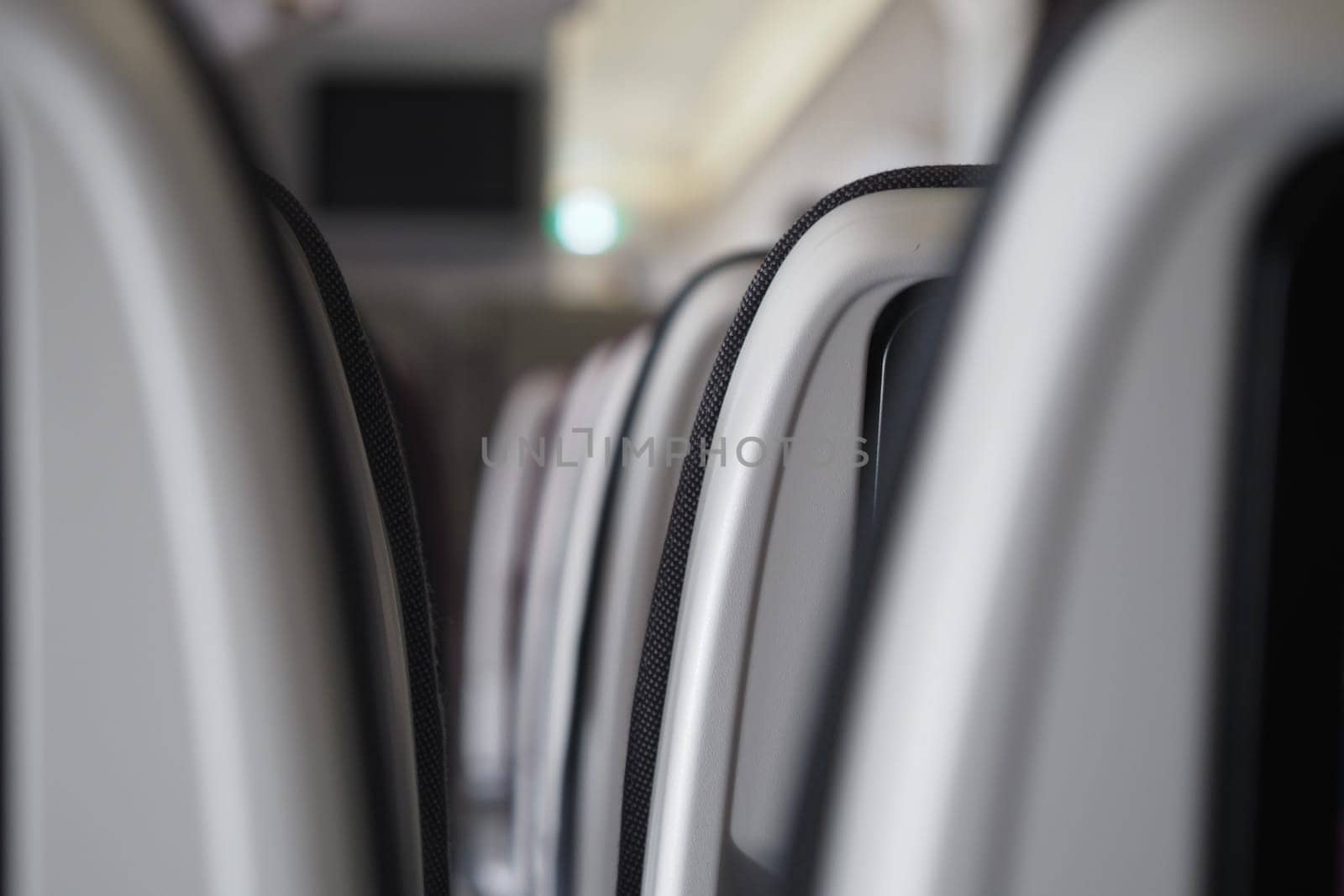 Focus on the rows of airplane seats in a spacious cabin setting.
