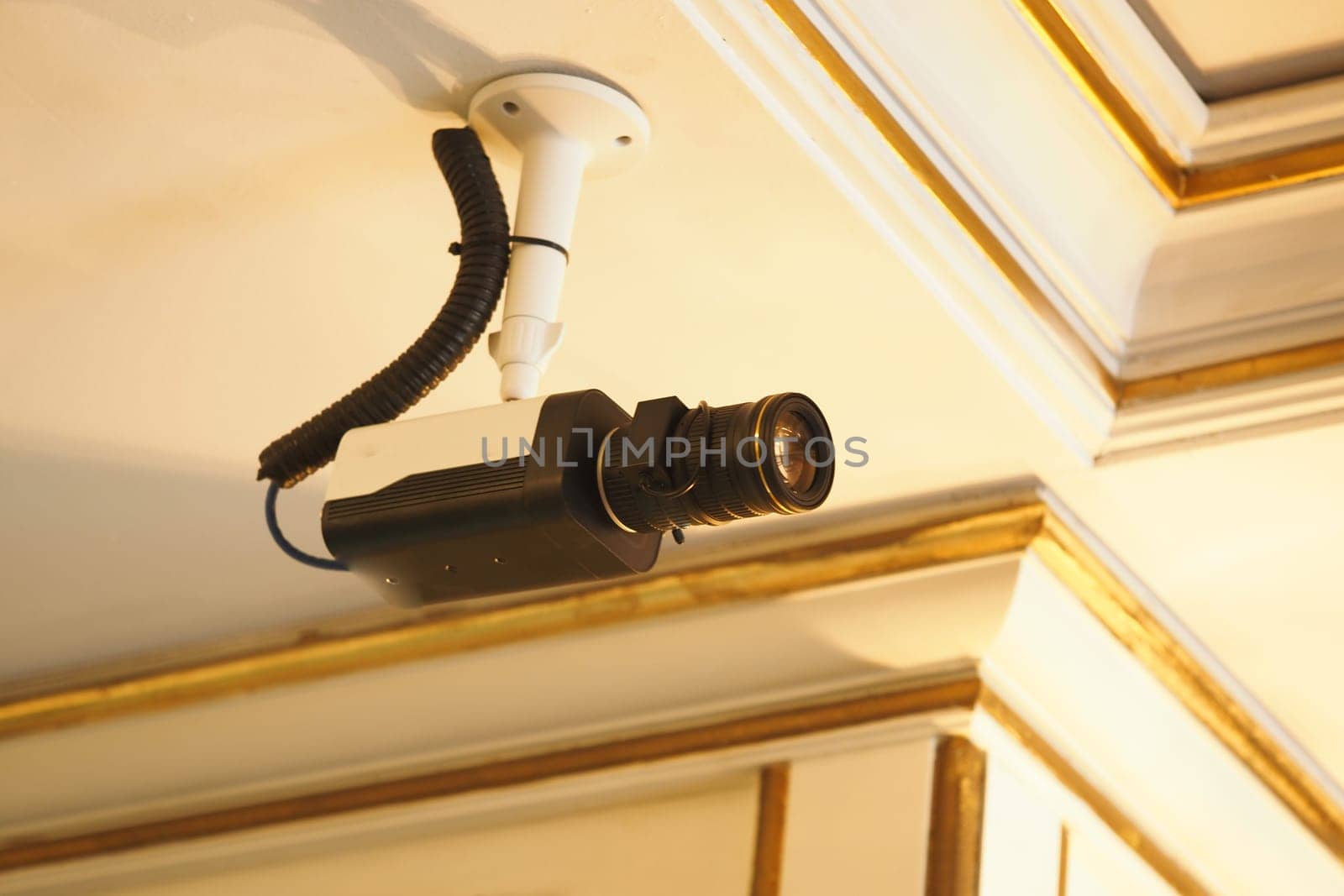 A security camera is attached to the ceiling, monitoring the area below.