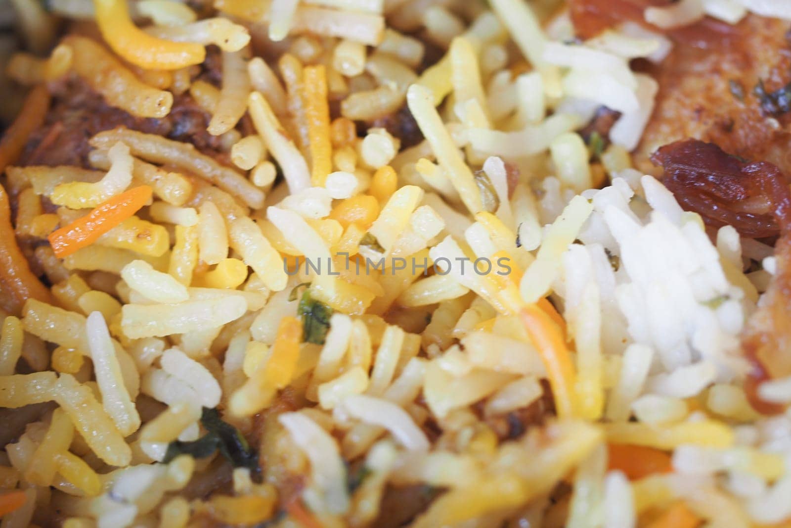 A vibrant mix of yellow and white rice with vegetables and spices.