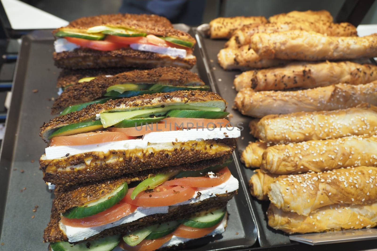 Tasty sandwiches with fresh veggies and cheese, plus pastries.
