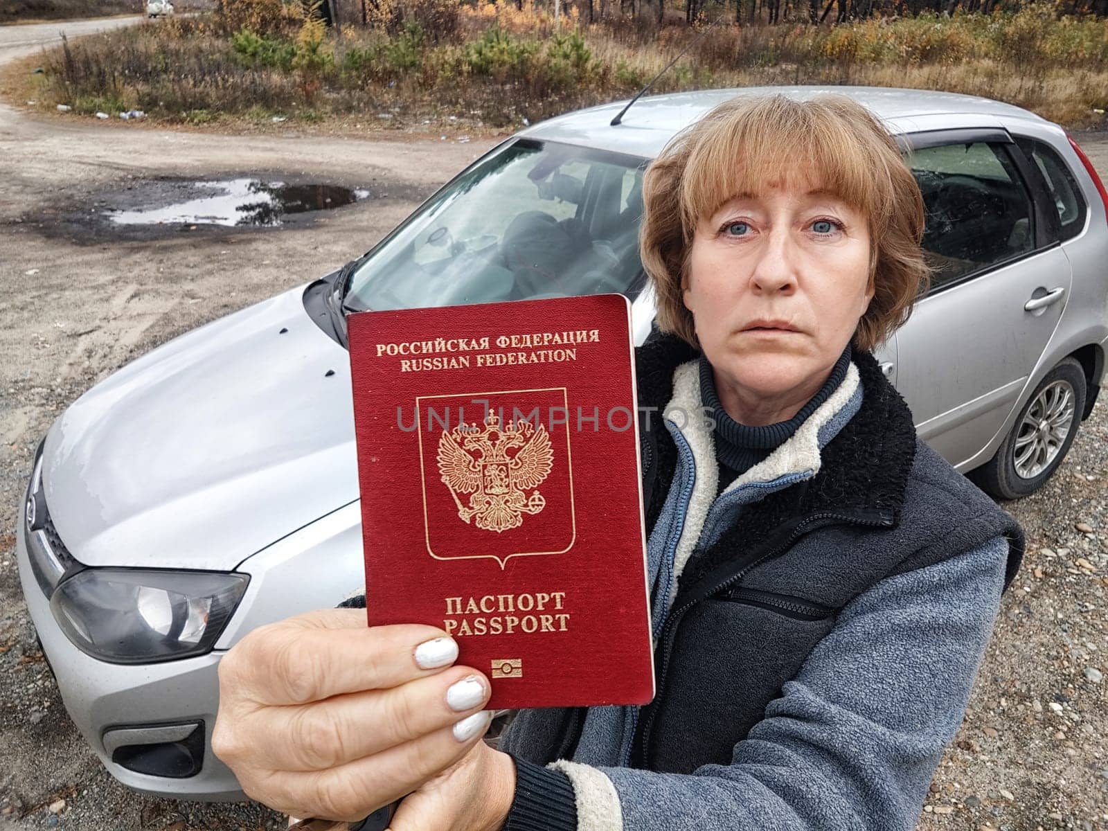 Driver girl with Russian passport and car. Russian cars banned for entering in Europe. Russian tourism closed during war of Russia and Uk. Confiscation of Russian car and sanctions against Russians