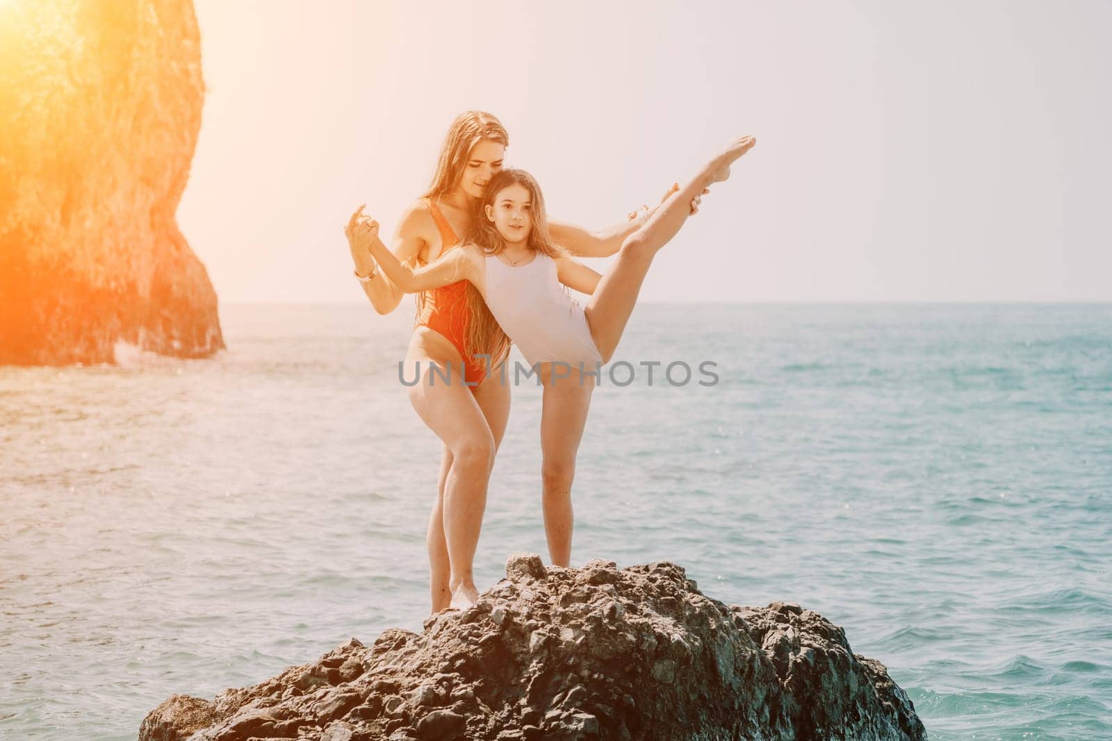 Silhouette mother and daughter doing yoga at beach. Woman on yoga mat in beach meditation, mental health training or mind wellness by ocean, sea