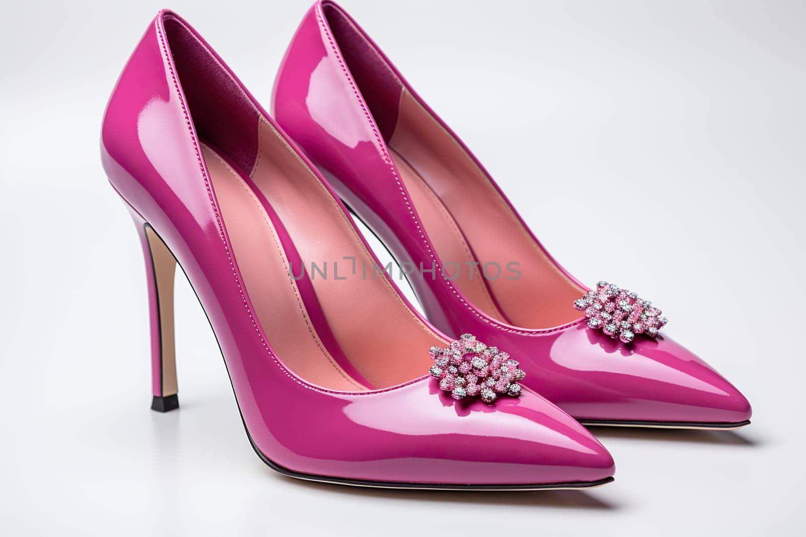 Elegant women's shoes made of pink leather with decoration on a white background. Women's shoes, side view. by Vovmar