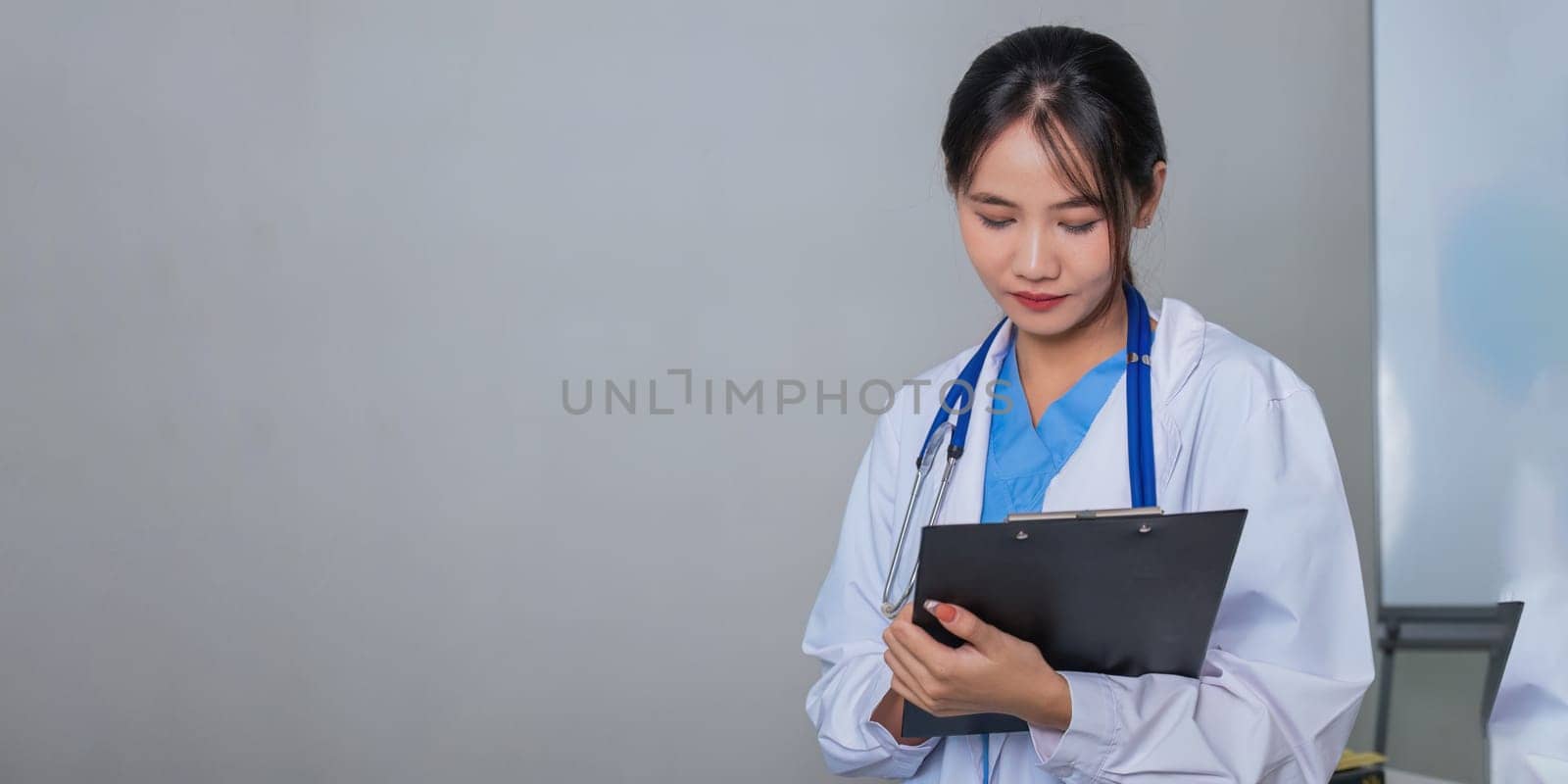 Medical concept of asian beautiful female doctor in white coat with stethoscope, waist up. medical by nateemee