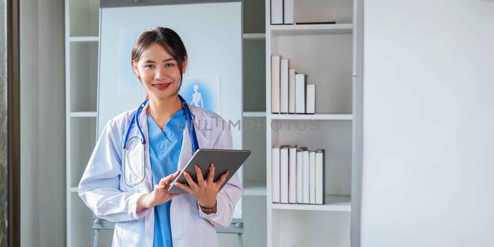 Medical concept of asian beautiful female doctor in white coat with stethoscope, waist up. medical.