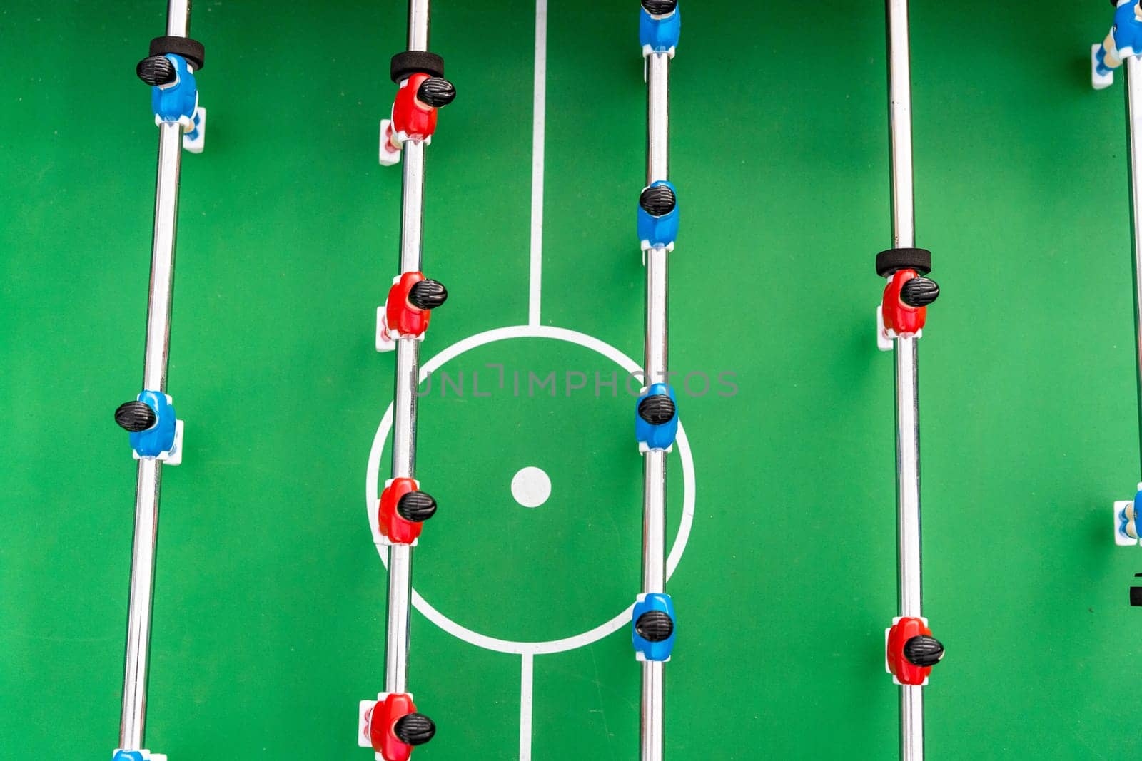 Table football. Top view of the football field and plastic players at a football match. red and blue players are hitting the ball. Championship