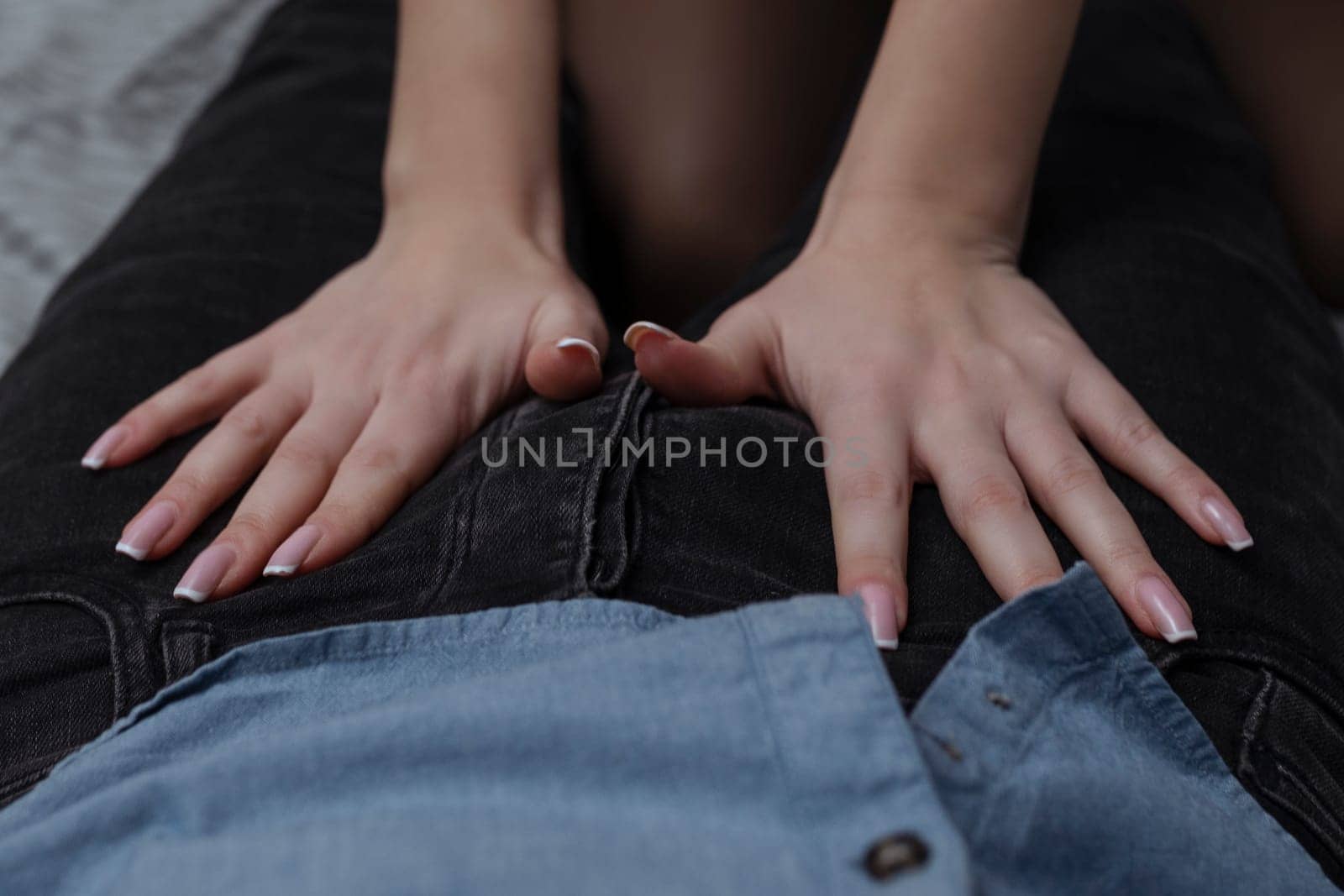 Work with your mouth. Sexy girl rubs the zipper on her partner's jeans for oral sex.