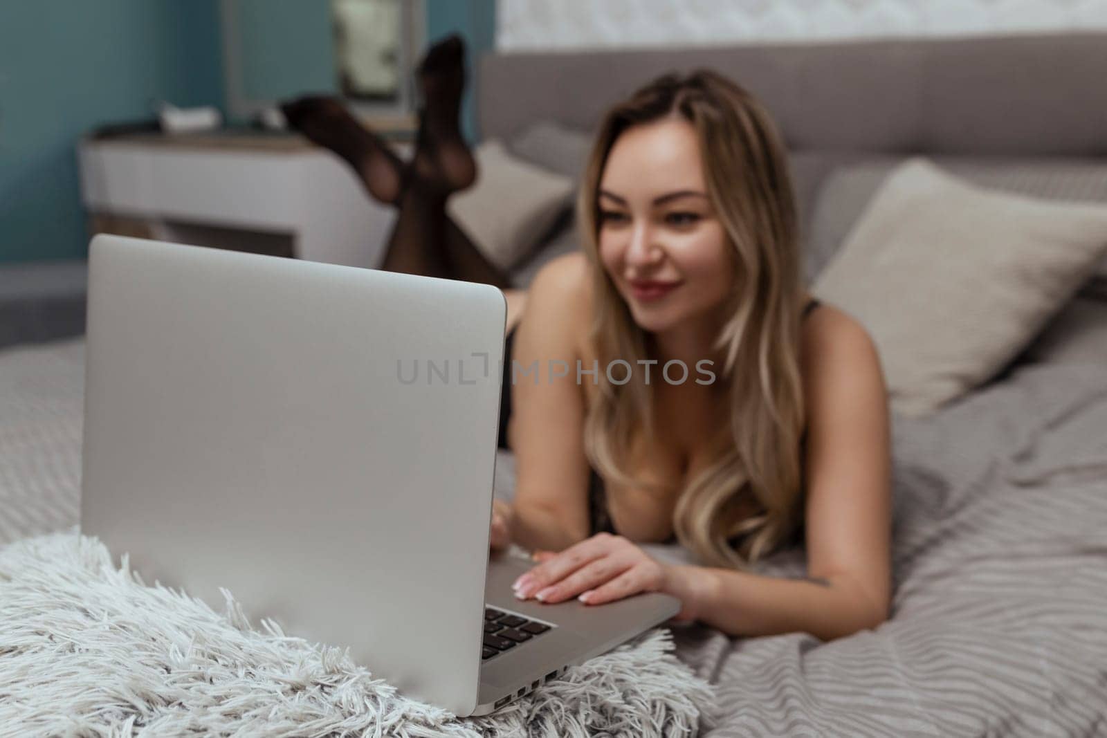 A beautiful, young girl shoots a webcam, works as a model. The concept of online flirting, sex on the Internet.