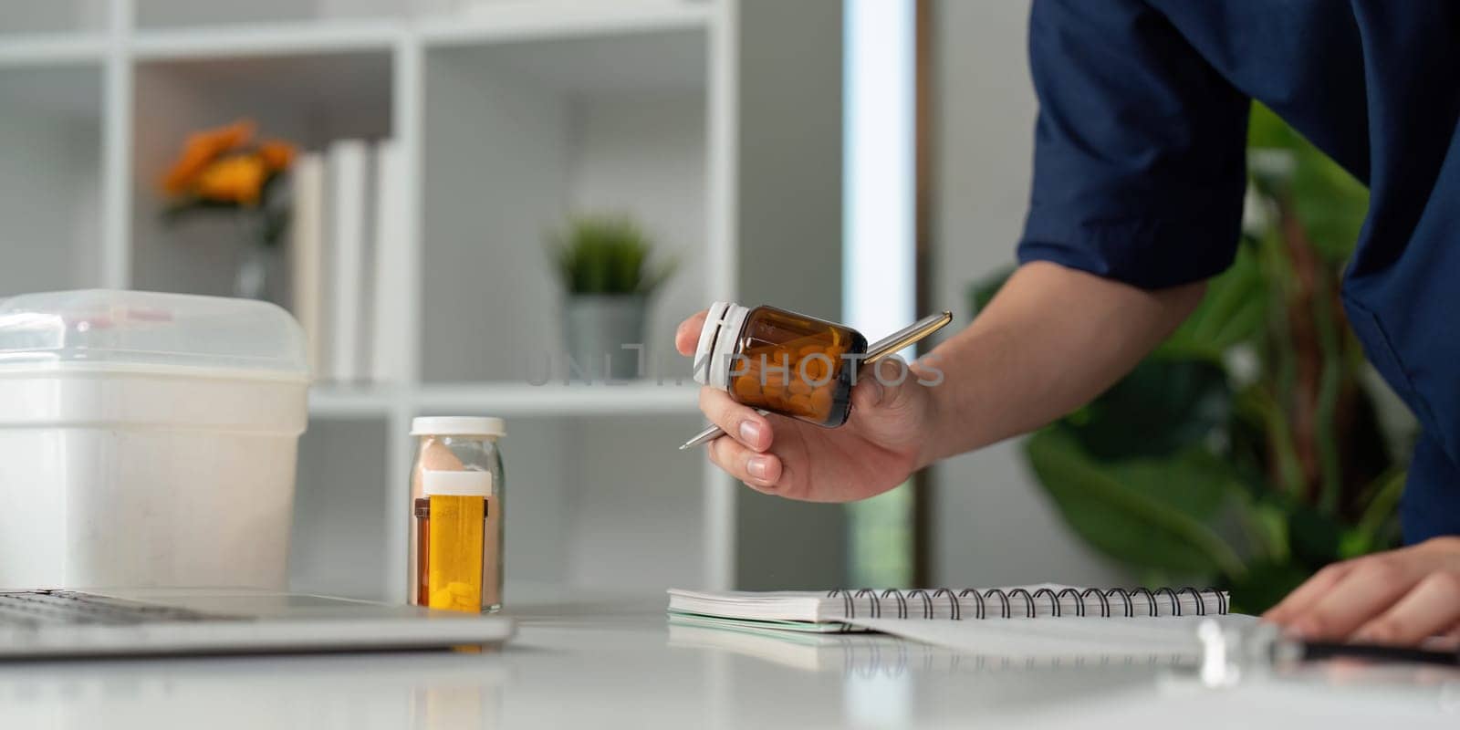 A thoughtful medical student reviews medication, emphasizing the importance of accuracy in healthcare.