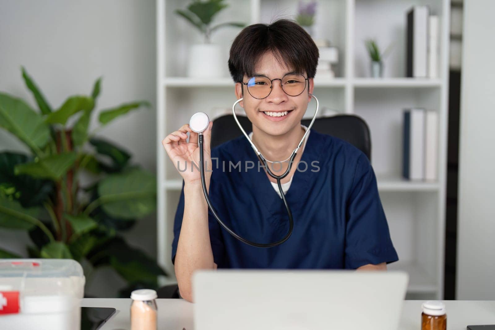 A joyful medical student in scrubs smiles while holding a stethoscope, embodying enthusiasm for healthcare and patient care.