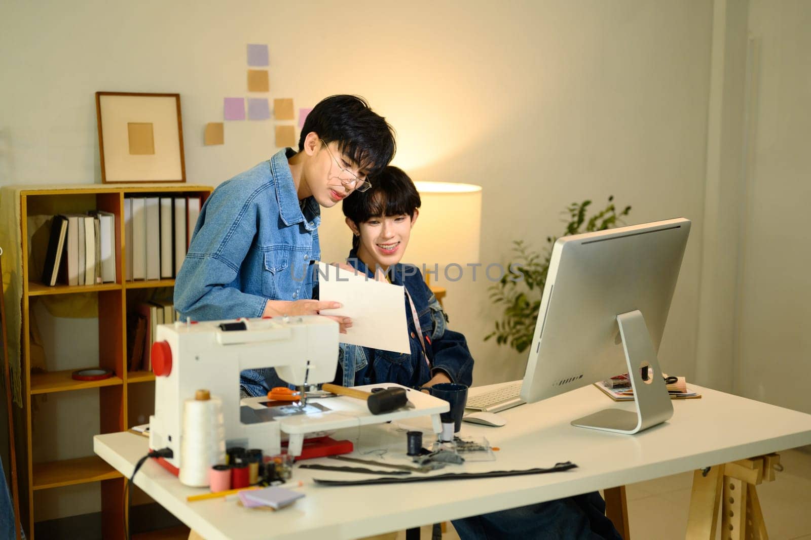 Fashion designers working on a creative project in stylish workspace.