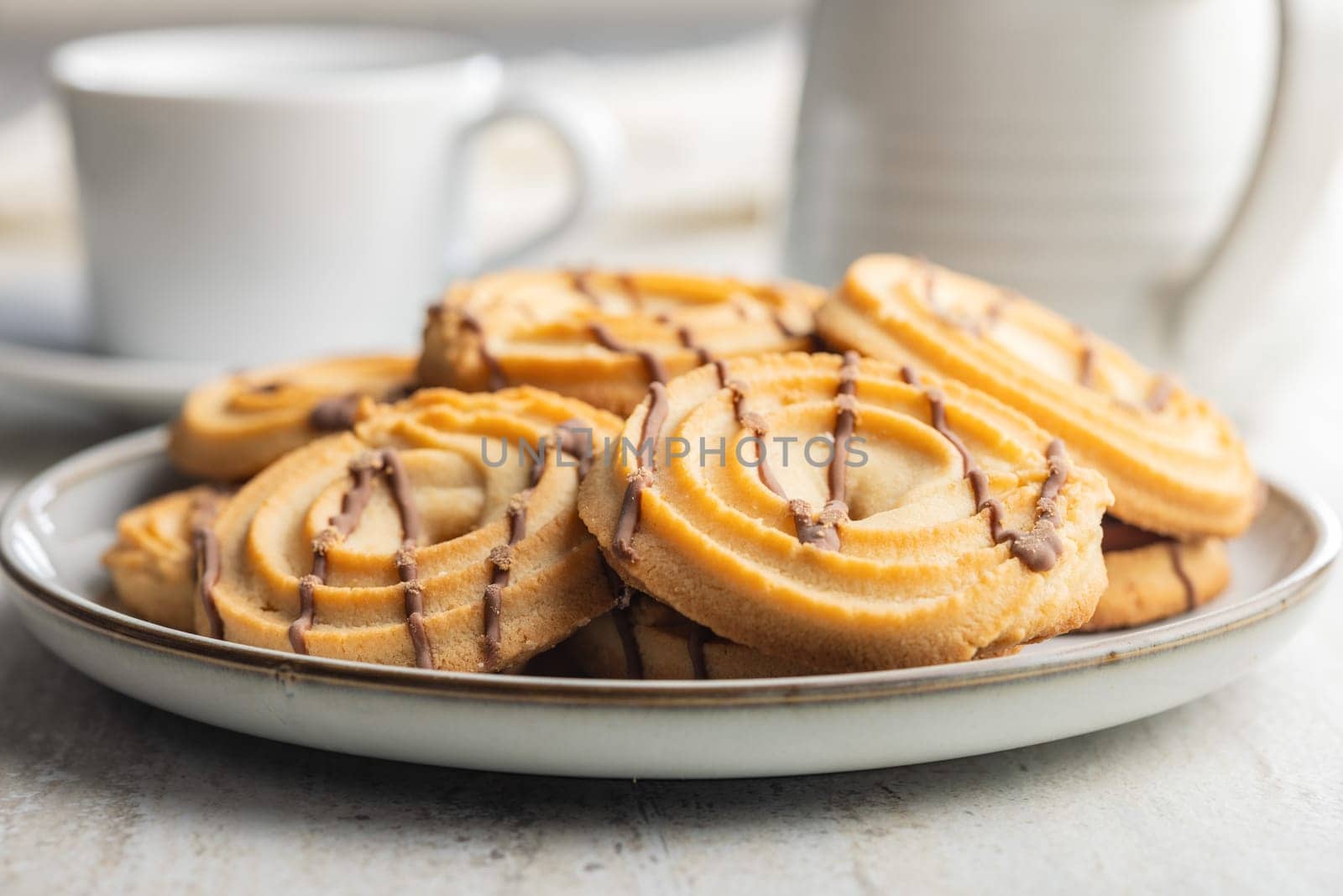 Sweet chocolate cookies on plate on a kitchen table.