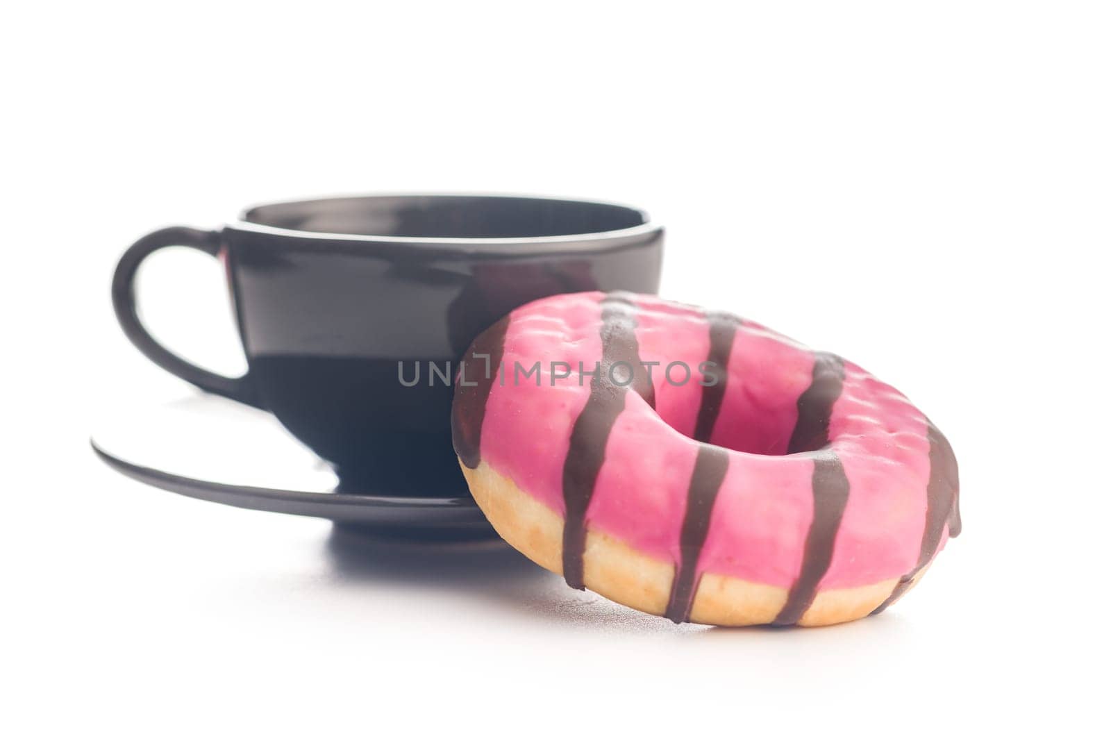 Sweet pink donut with chocolate strips and coffee cup isolated on a white background.