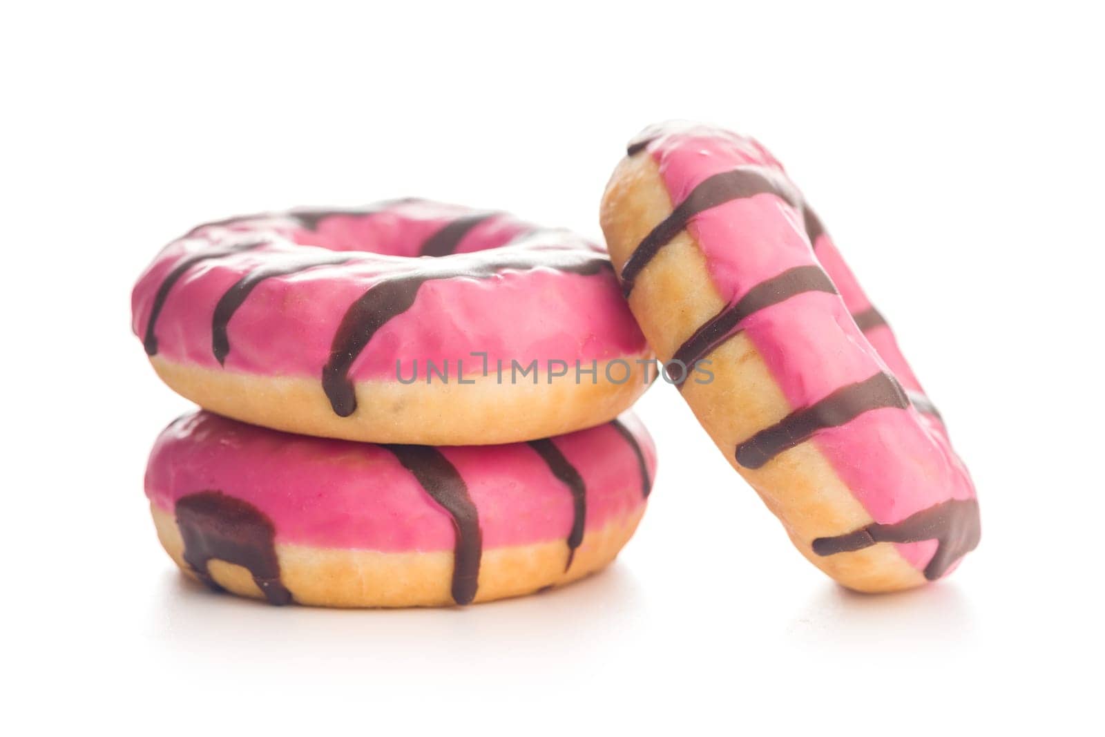 Sweet pink donut with chocolate strips isolated on a white background.