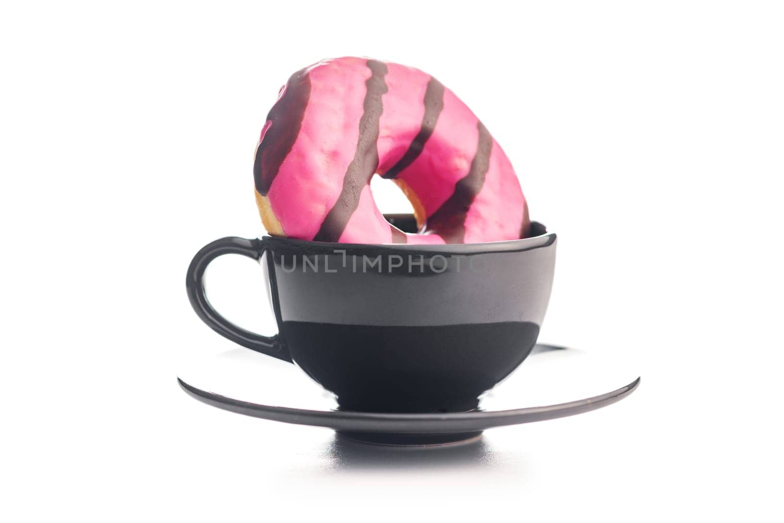 Sweet pink donut with chocolate strips and coffee cup isolated on a white background.