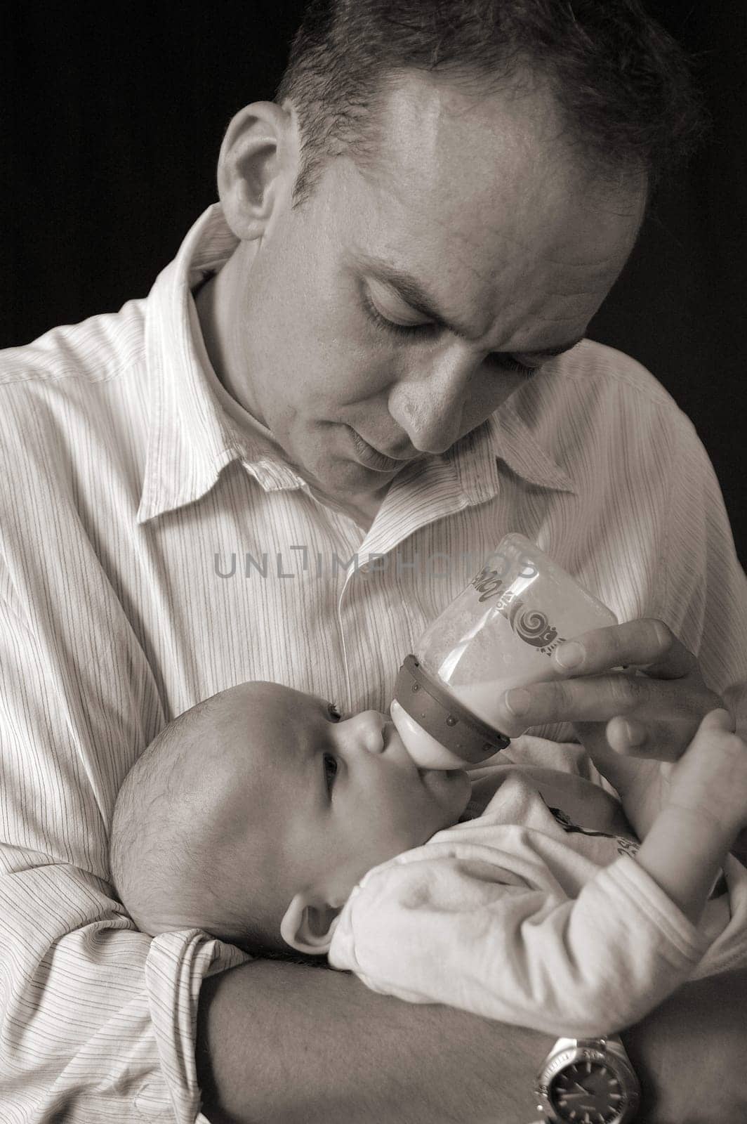 Father breastfeeding daughter