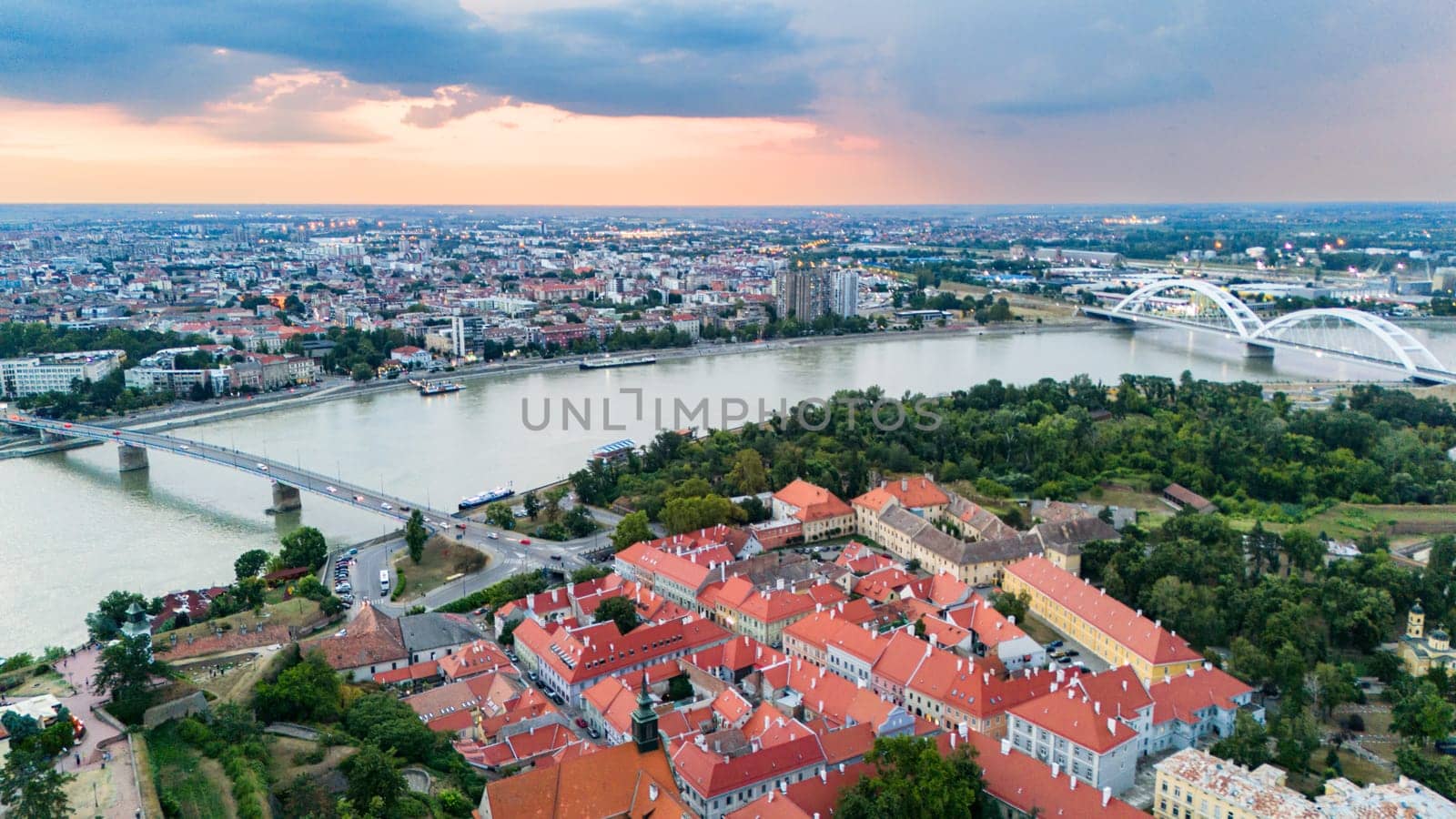 Aerial view of Novi Sad Serbia with Petrovaradin fortress and Danube river during sunset