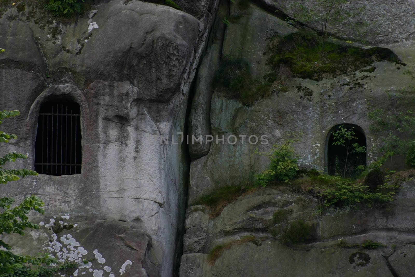 Barred window openings in the external stones. Behind it are two rock grotes,which unfortunately are no longer open to the public