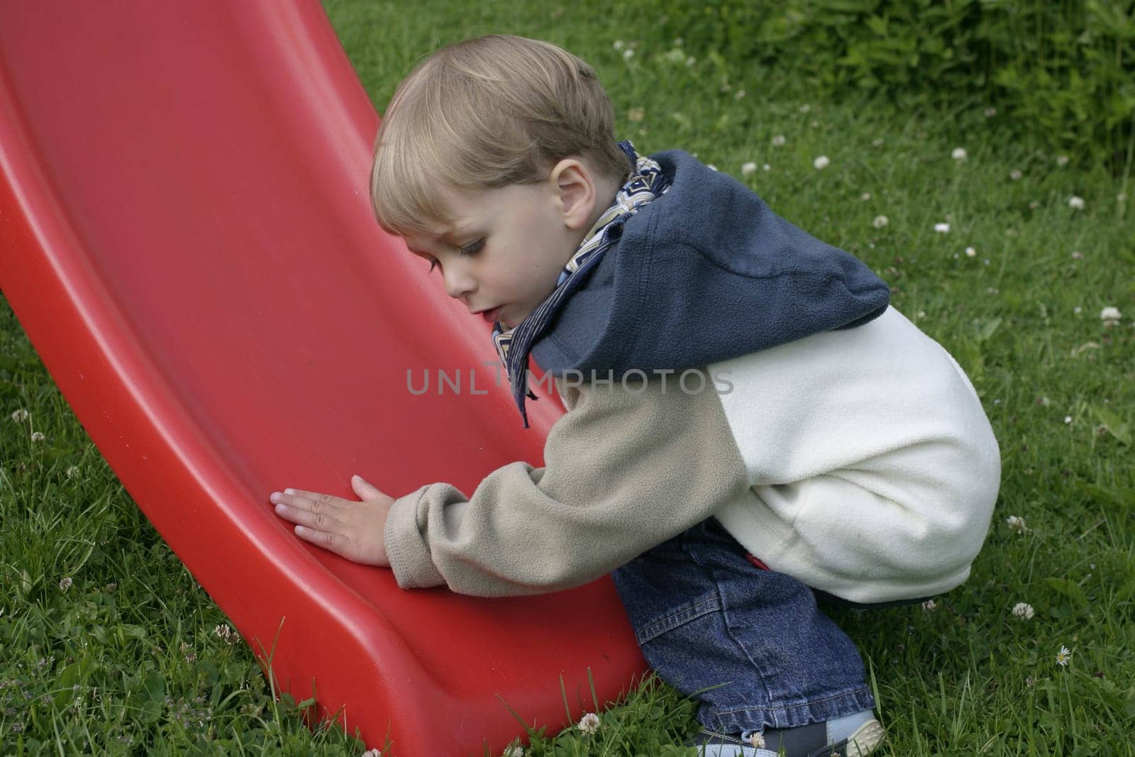 Boy tries to see if the slide is wet