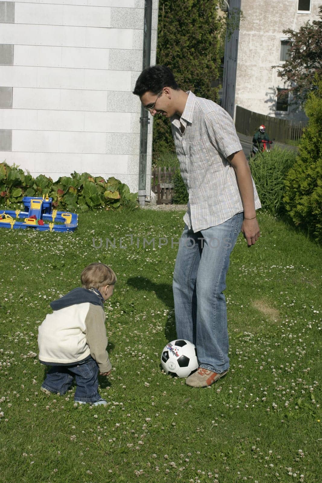 Father and son playing football