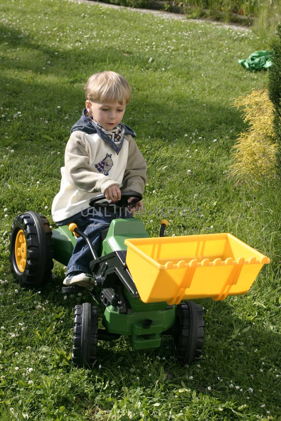 Boy playing with the toy excavator