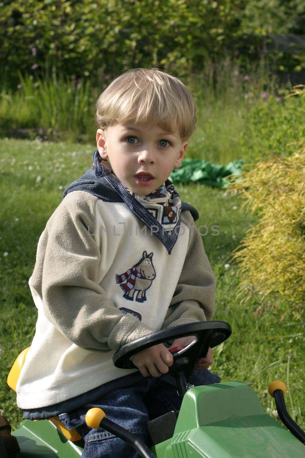 Boy honking his horn driving toy excavator