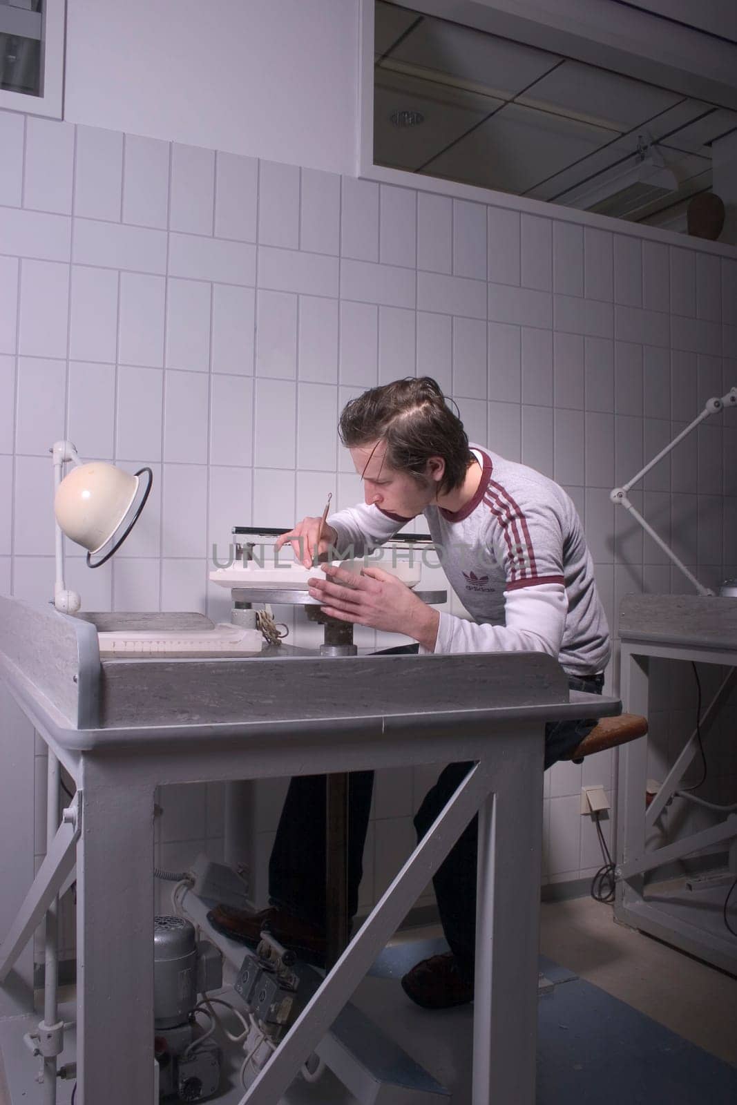 Vocational school students working on a plaster mold for the production of logo porcelain