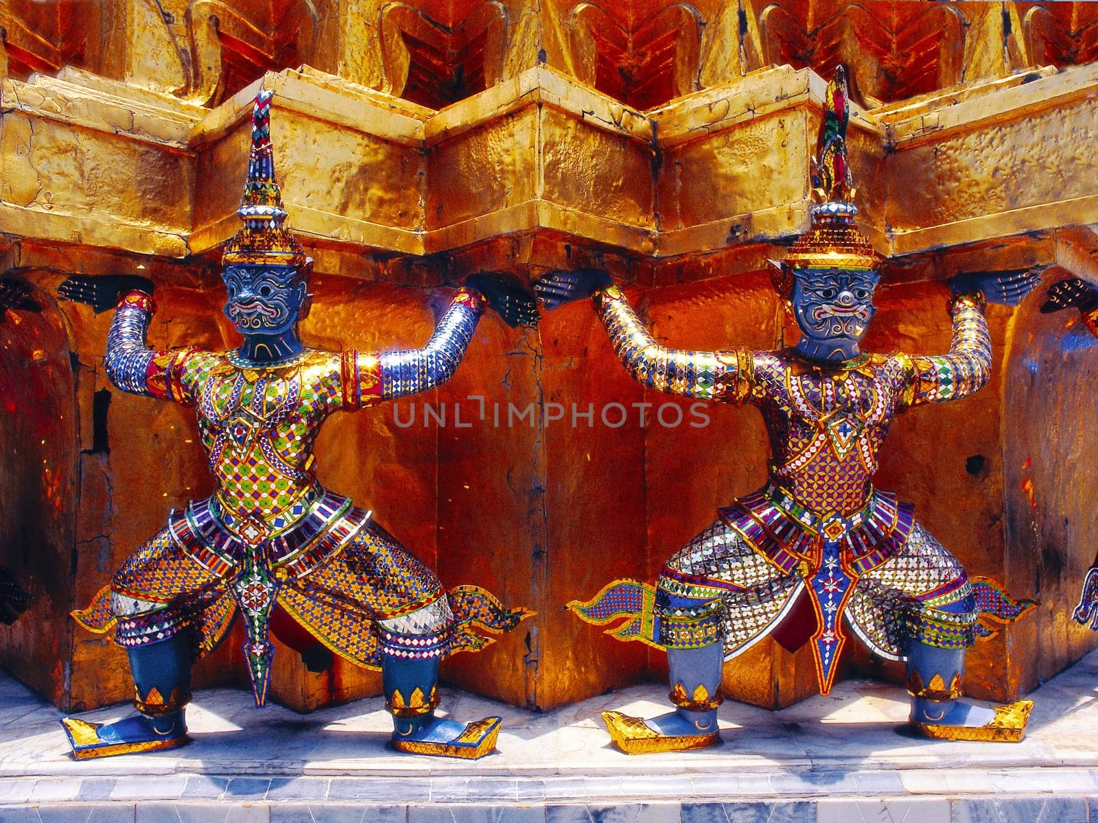 Terrifying temple guards prop up a "chedi"" at Wat Phra Kaeo in Bankok. Rama I had the temple complex built to commemorate the destroyed royal city of Ayutthaya. (Data up to poster size available)"