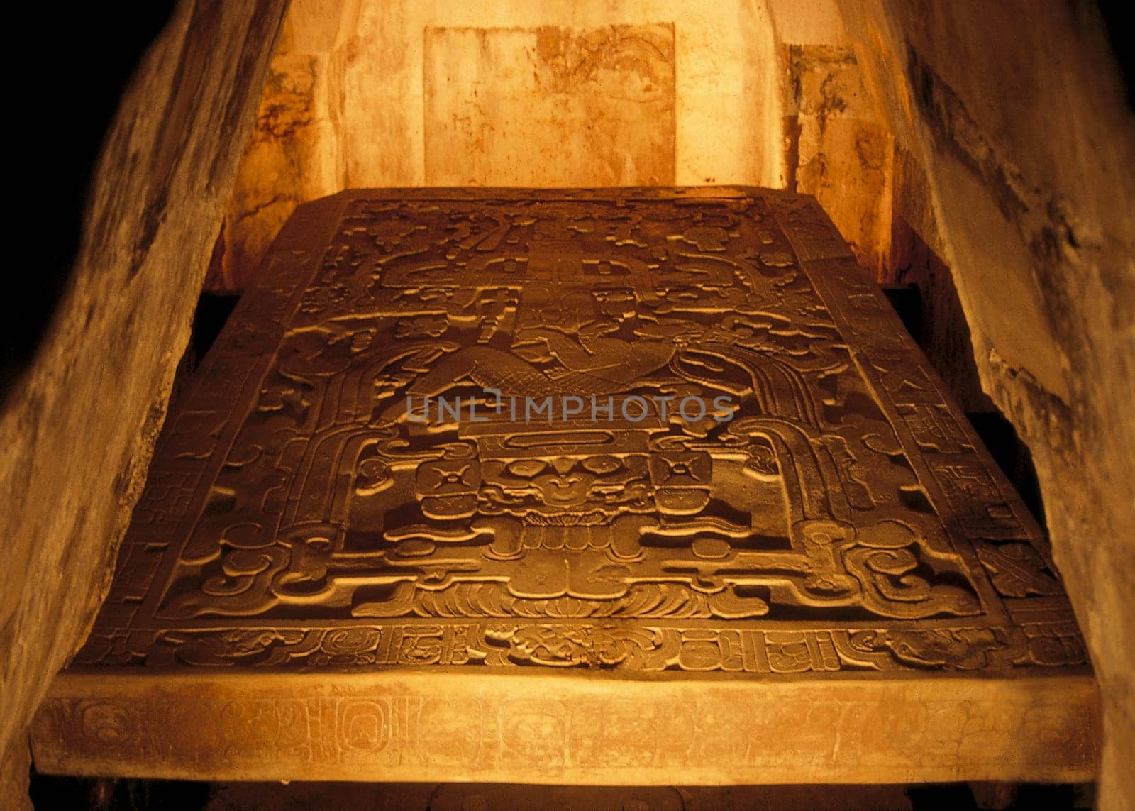The burial chamber under the Temple of Inscriptions. Today you can only admire it behind a tarnished plexiglass pane,the plate with the dimensions 3.8m x 2.2m,a thickness of 25cm,and a weight of several tons.