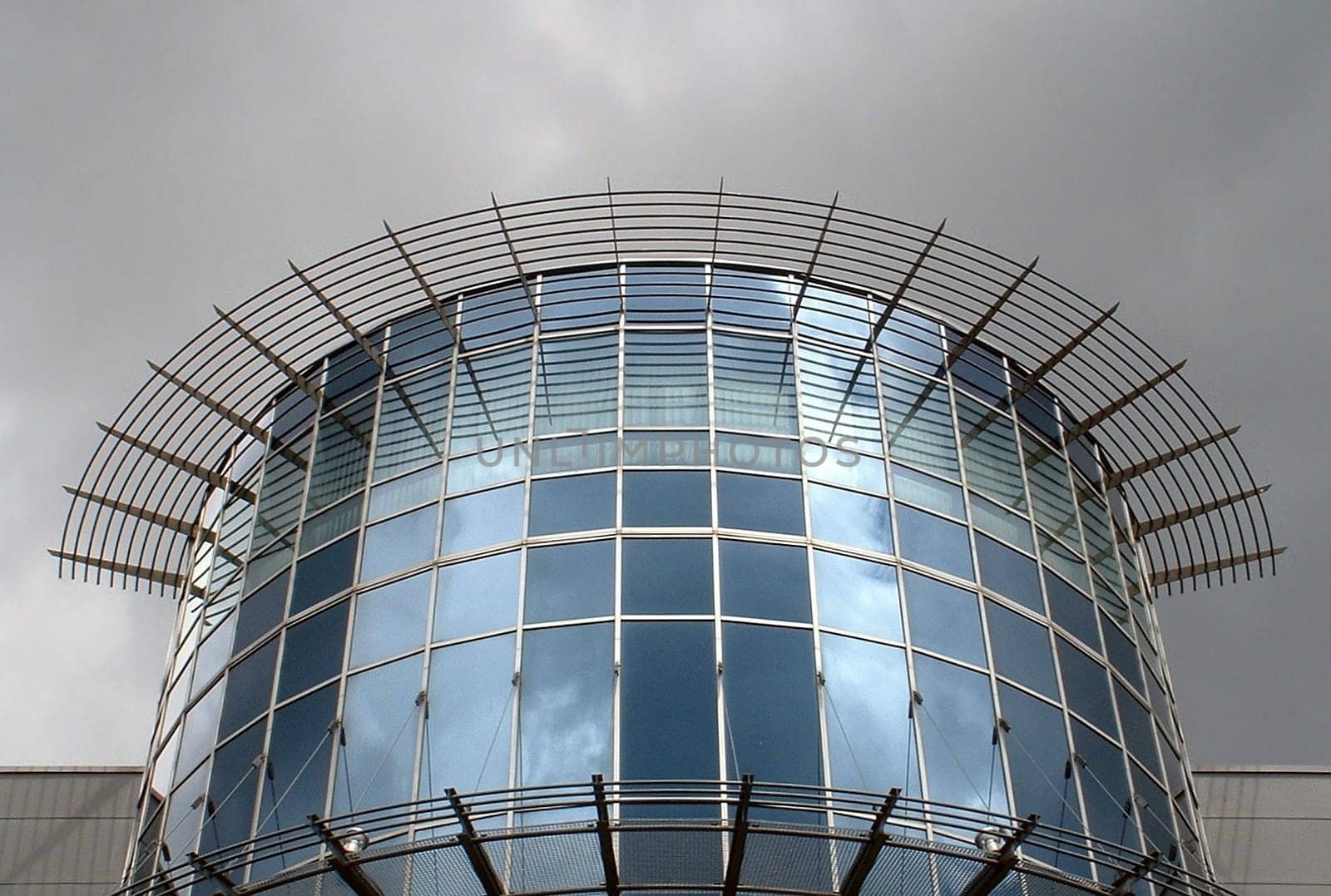 Detail of a cinema just before a downpour. However,the sun was still shining behind me at the time of the picture. Hence the illuminated glass front.