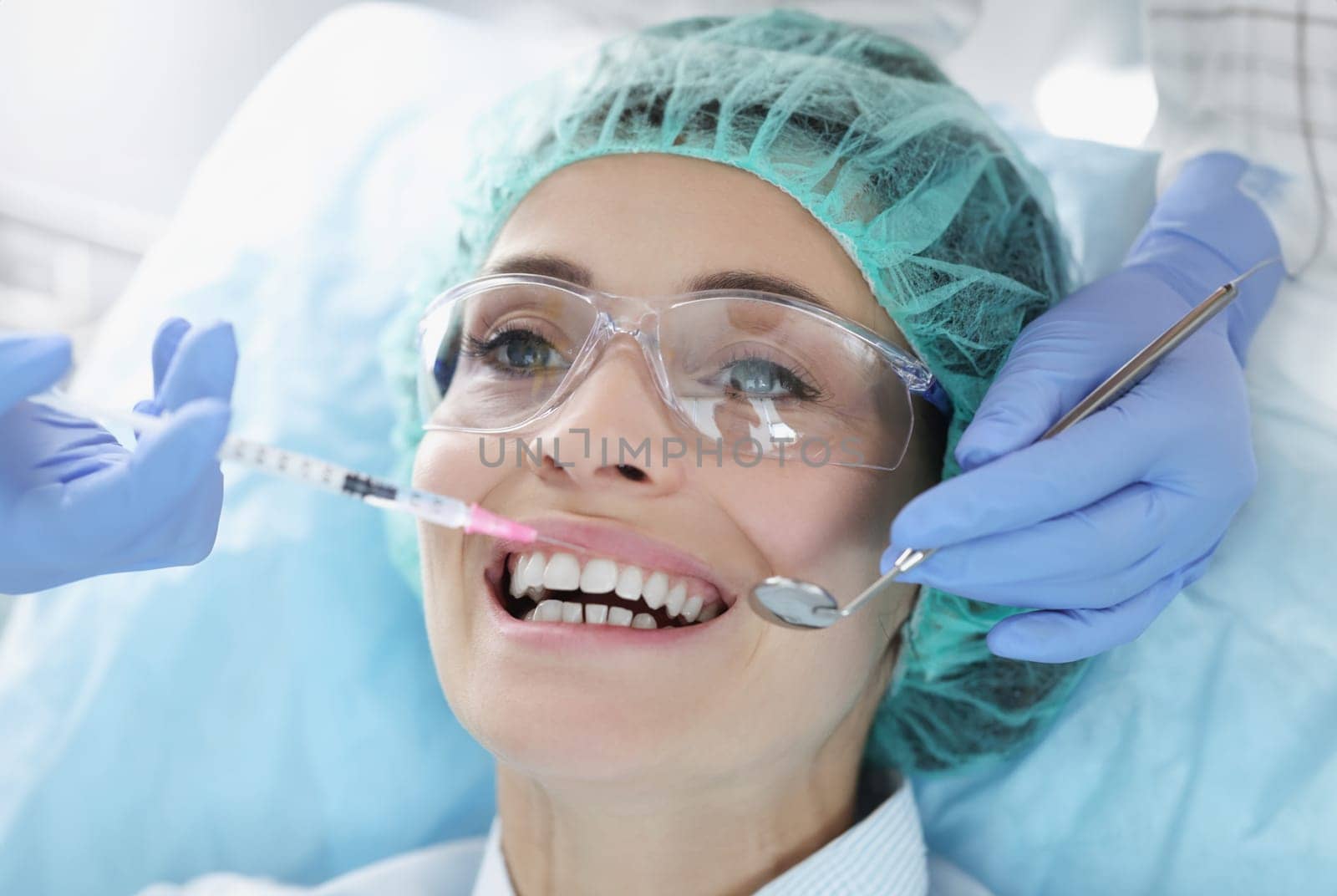 Doctor gives woman an anesthetic injection closeup by kuprevich