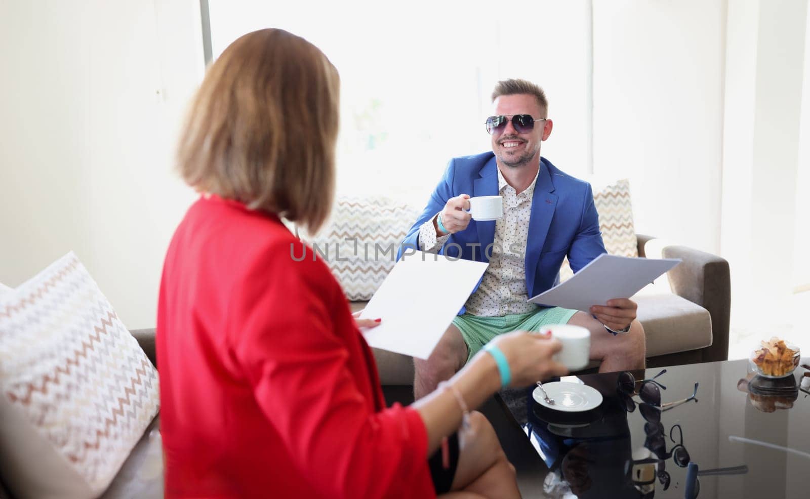 Businesswoman and businessman drink coffee and discuss signing an agreement. Business meetings and introduction of negotiations. concept