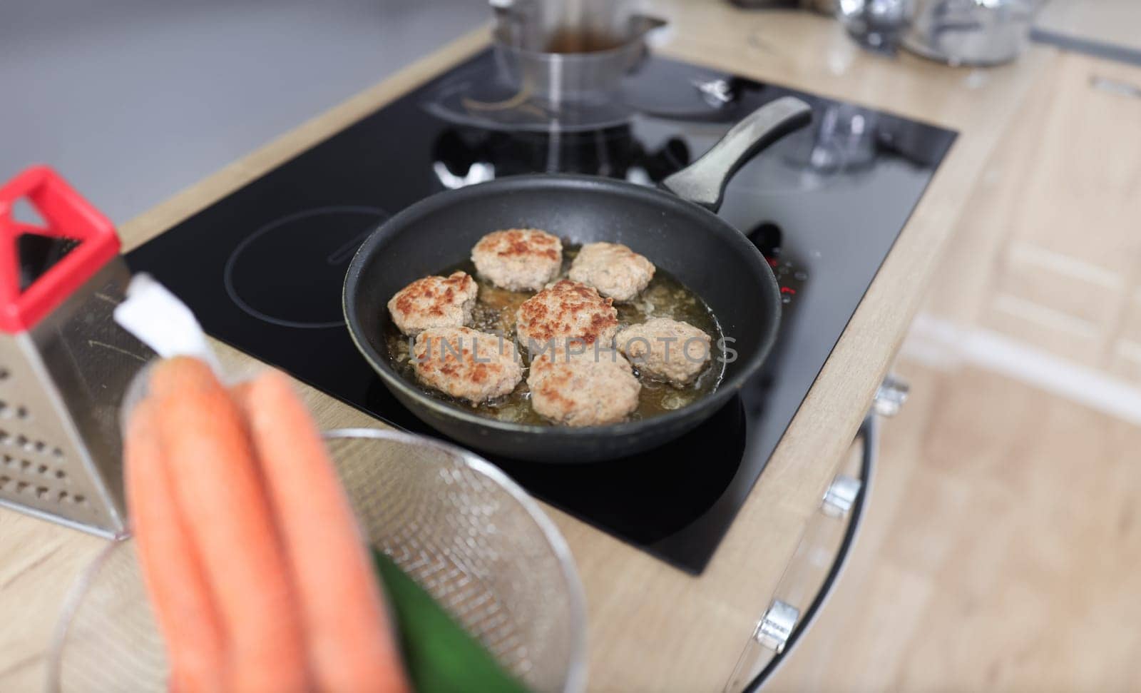 In kitchen, cutlets are fried in frying pan. Home cooking concept