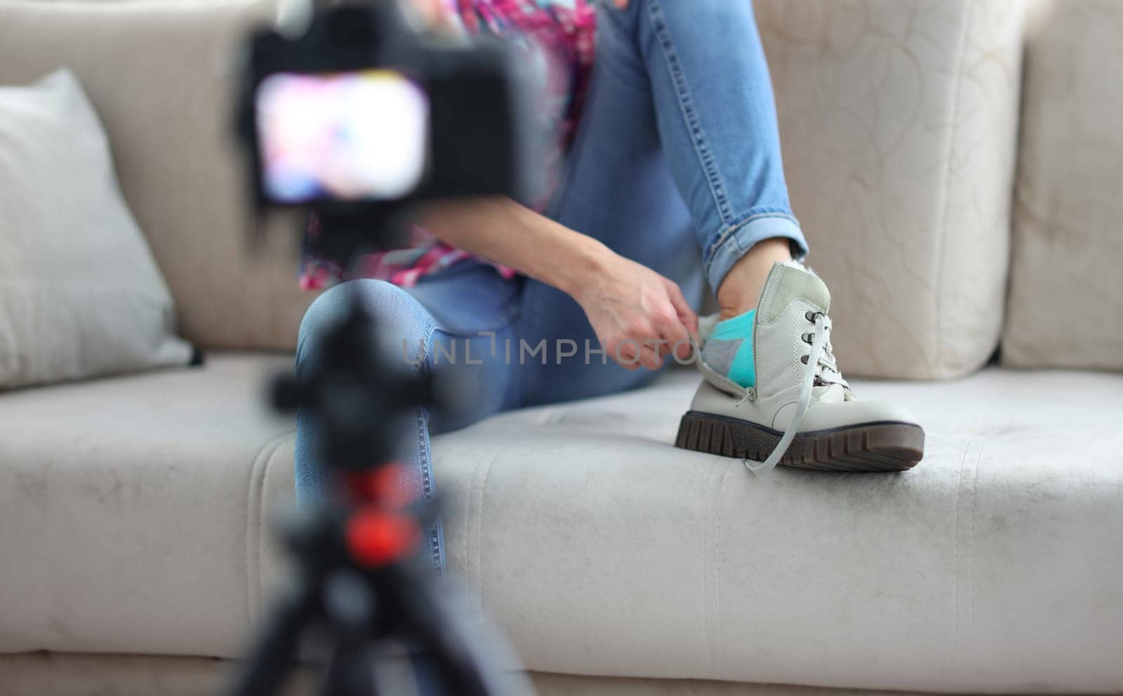 Blogger is filming an overview of boots by kuprevich