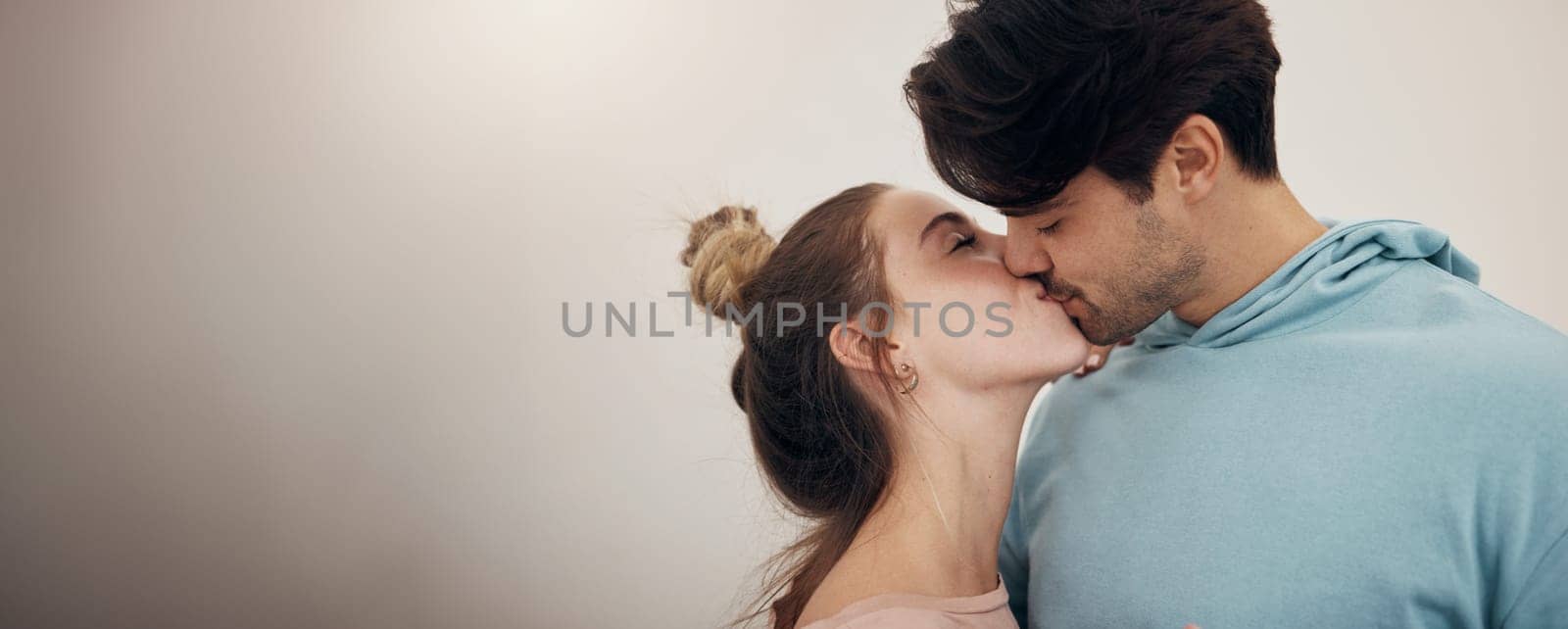 Happy, couple and kiss with love in banner, white background or studio mockup of partnership, loyalty or marriage. Romantic, people or bonding with partner in affection with support and care together.