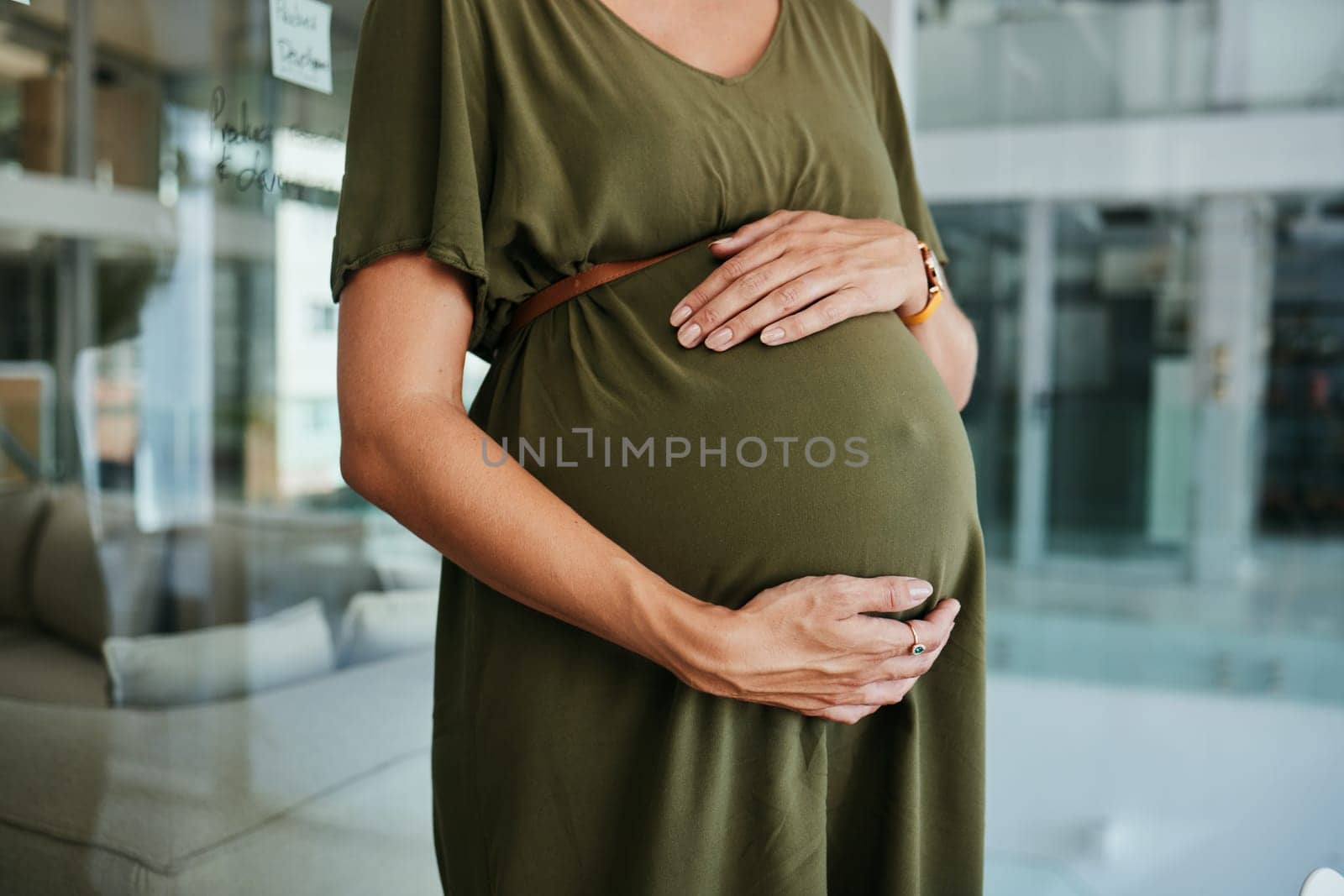 Pregnancy care, stomach and hands of woman feeling, massage and touch baby development, body or belly. Maternity, office closeup and pregnant person love, support and hope for future motherhood.