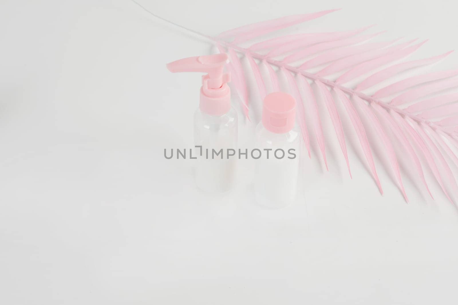 Beauty cosmetics glassbottle. branding mock up, front view on pastel pink and white background. Package for essential oil.