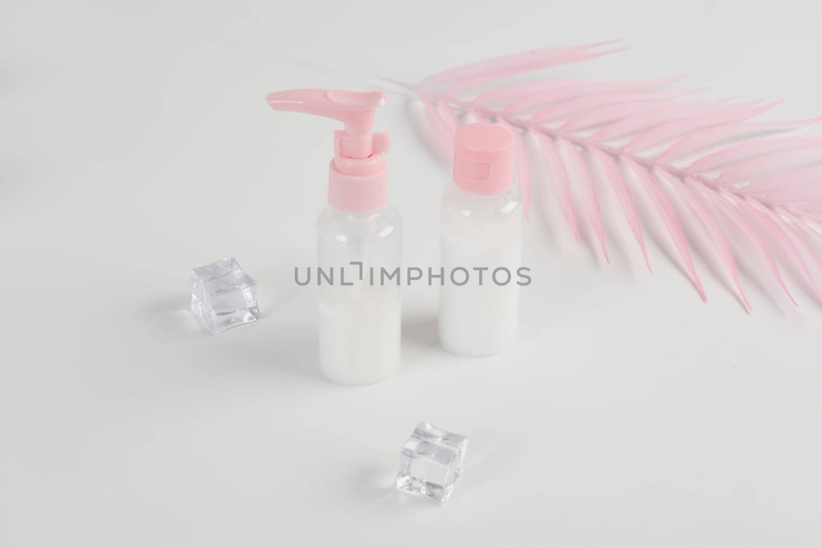 Beauty cosmetics glassbottle. branding mock up, front view on pastel pink and white background. Package for essential oil.