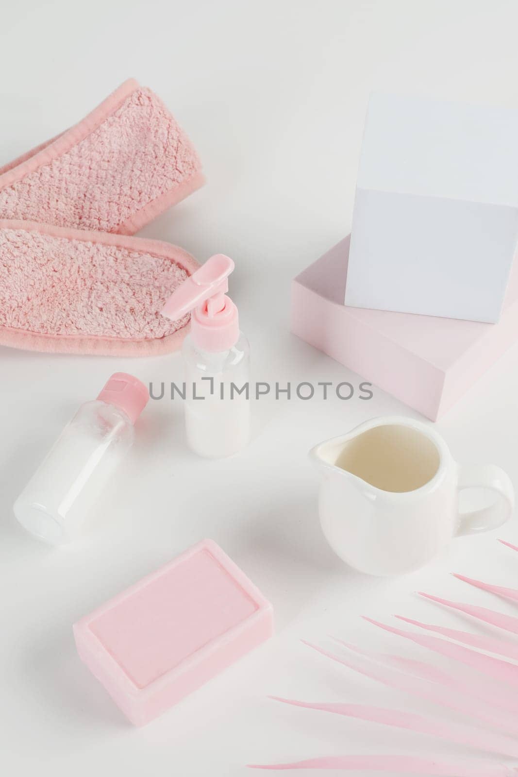 Skincare routine. Pink Women skincare products on white background. Soap, facial foam, cleansing, serum, cream lotion, toothbrush, lipstick. Beauty concept. Natural cosmetic pink flat lay top view.